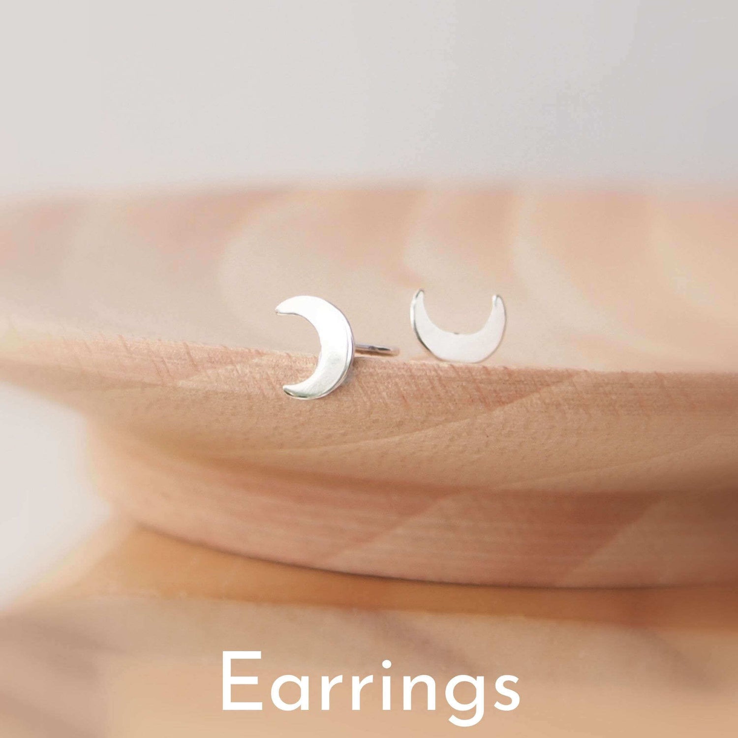 Small crescent moon stud earrings in Sterling Silver, handmade by maram jewellery in Scotland