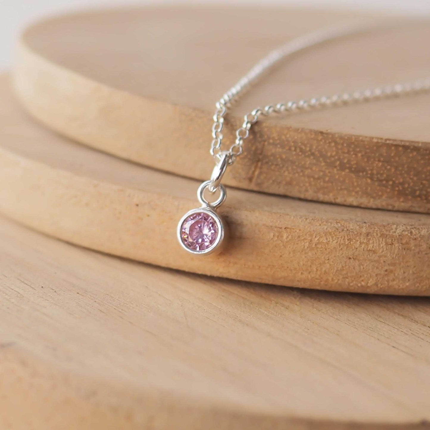 Small Sterling Silver and Cubic Zirconia Pink necklace. A small 4mm facet round pale pink gemstone with a simple silver setting on a trace style chain, suitable as a June Birthstone charm . Handmade in Scotland by Maram Jewellery