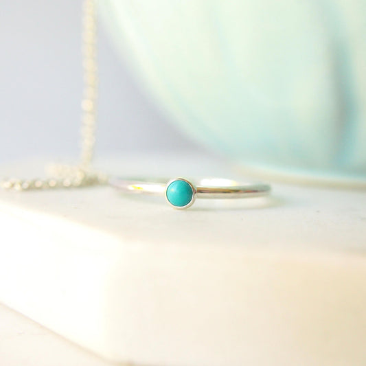 Dainty Turquoise and Sterling Silver Ring made from a small 3mm round turquoise gemstone set simply onto a modern band of round wire. Handmade to your ring size by maram jewellery in Scotland.