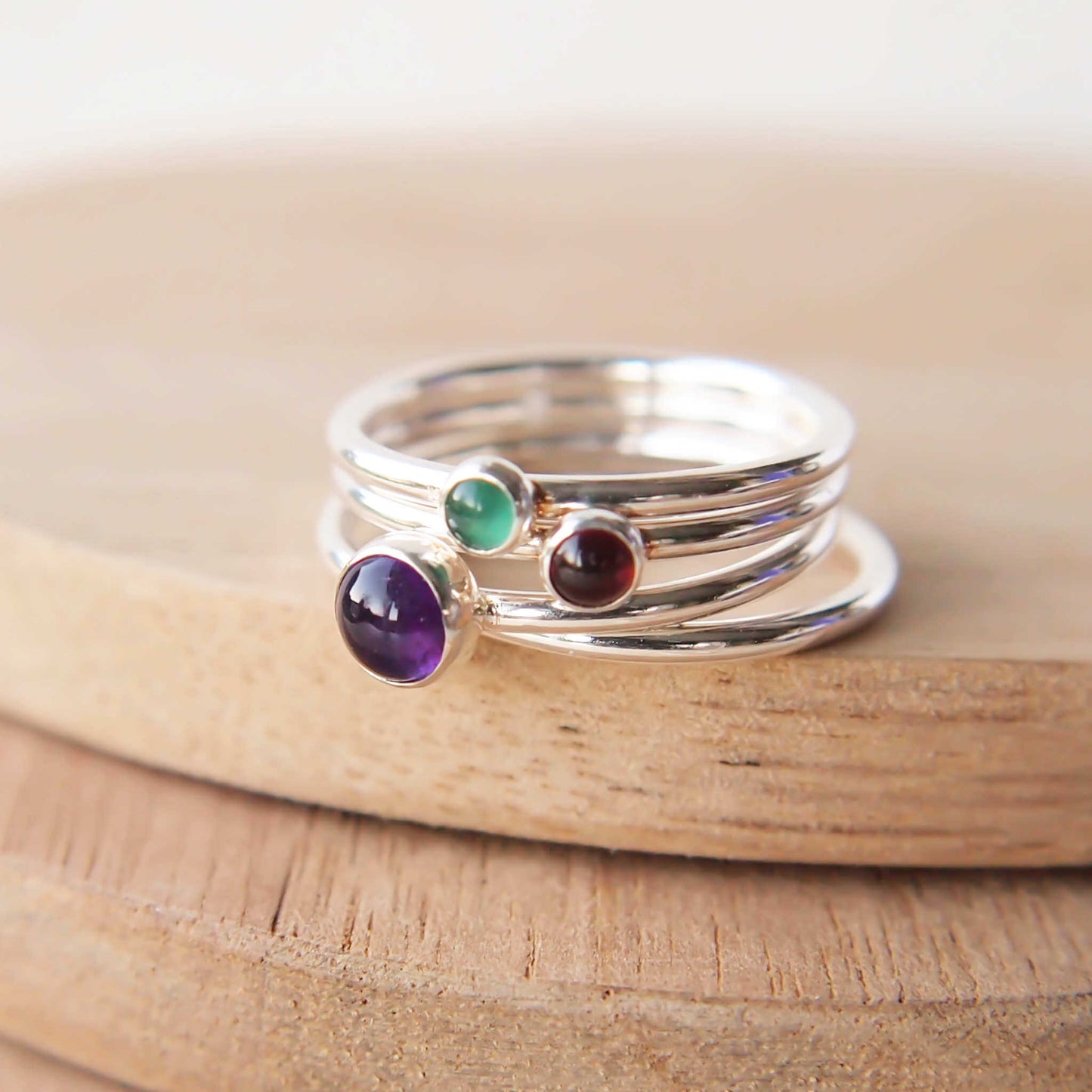 Three ring birthstone ring set made from sterling silver and three gemstones. This set has Amethyst, Garnet and Green Agate. Handmade in Scotland by Maram Jewellery