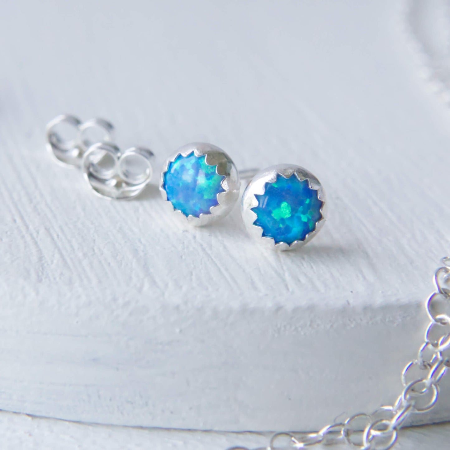 Lab Blue Opal Silver earrings, round with a serrated edge in a 5mm size. Made from Sterling Silver, handmade by maramjewellery in Edinburgh UK