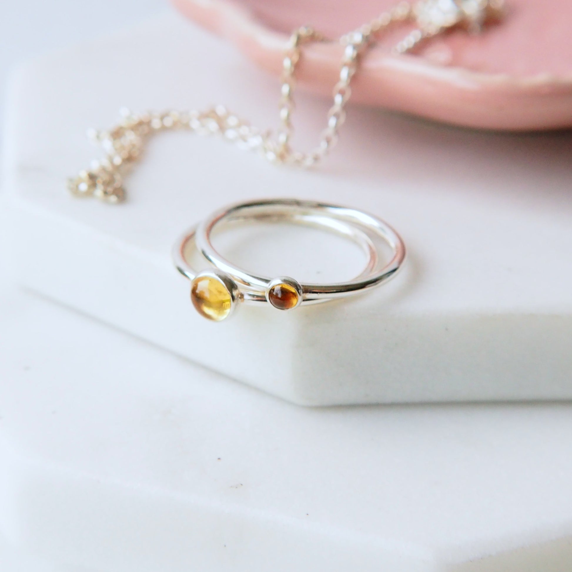 Two ring set in Sterling Silver and Citrine. The rings have two round cabochons in 5mm and 3mm size in a warm yellow colour, and are set very simply onto bands of Sterling Silver. Handmade in Scotland by Maram Jewellery