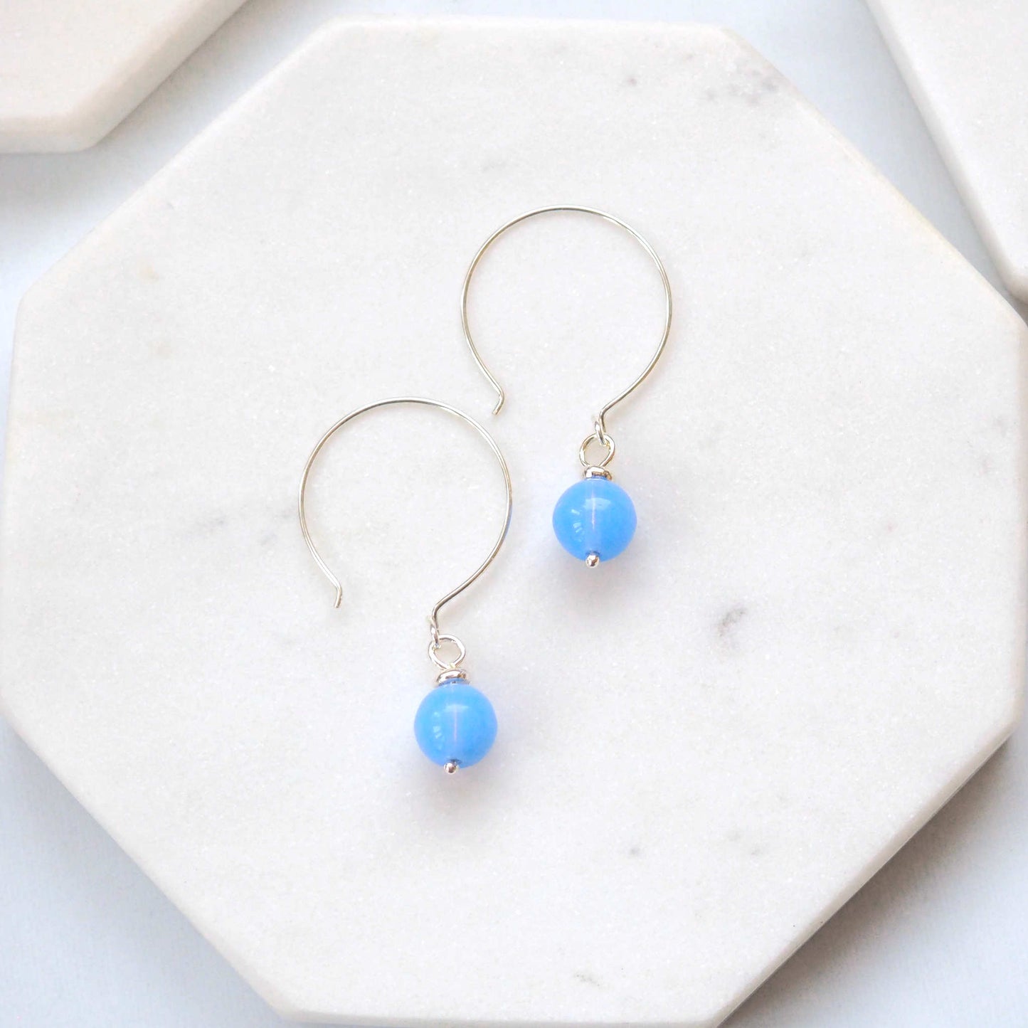 Pale baby blue Silver minimalist handmade silver hoops. Handcrafted ear wires with a round glass bead dropper. Made in Scotland by maram jewellery