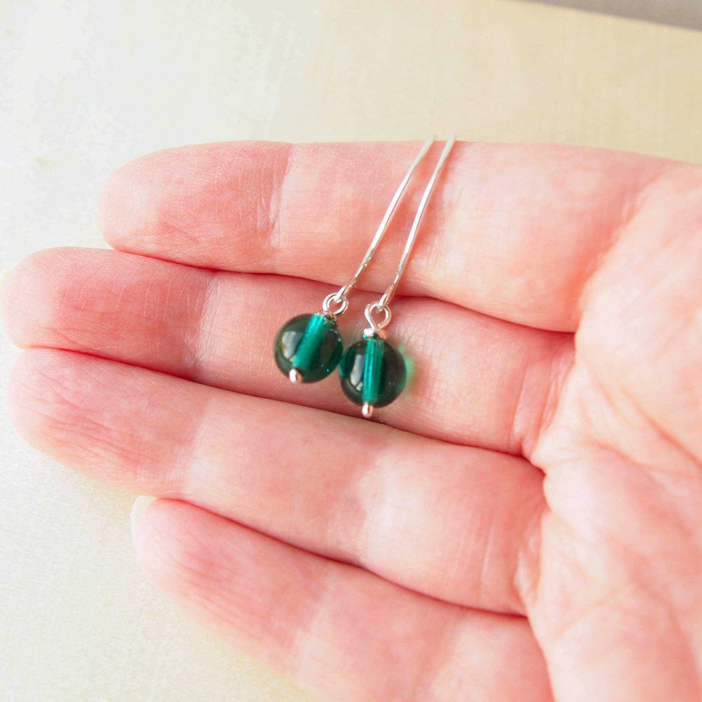 Green Silver minimalist handmade silver hoops. Handcrafted ear wires with a round glass bead dropper. Made in Scotland by maram jewellery