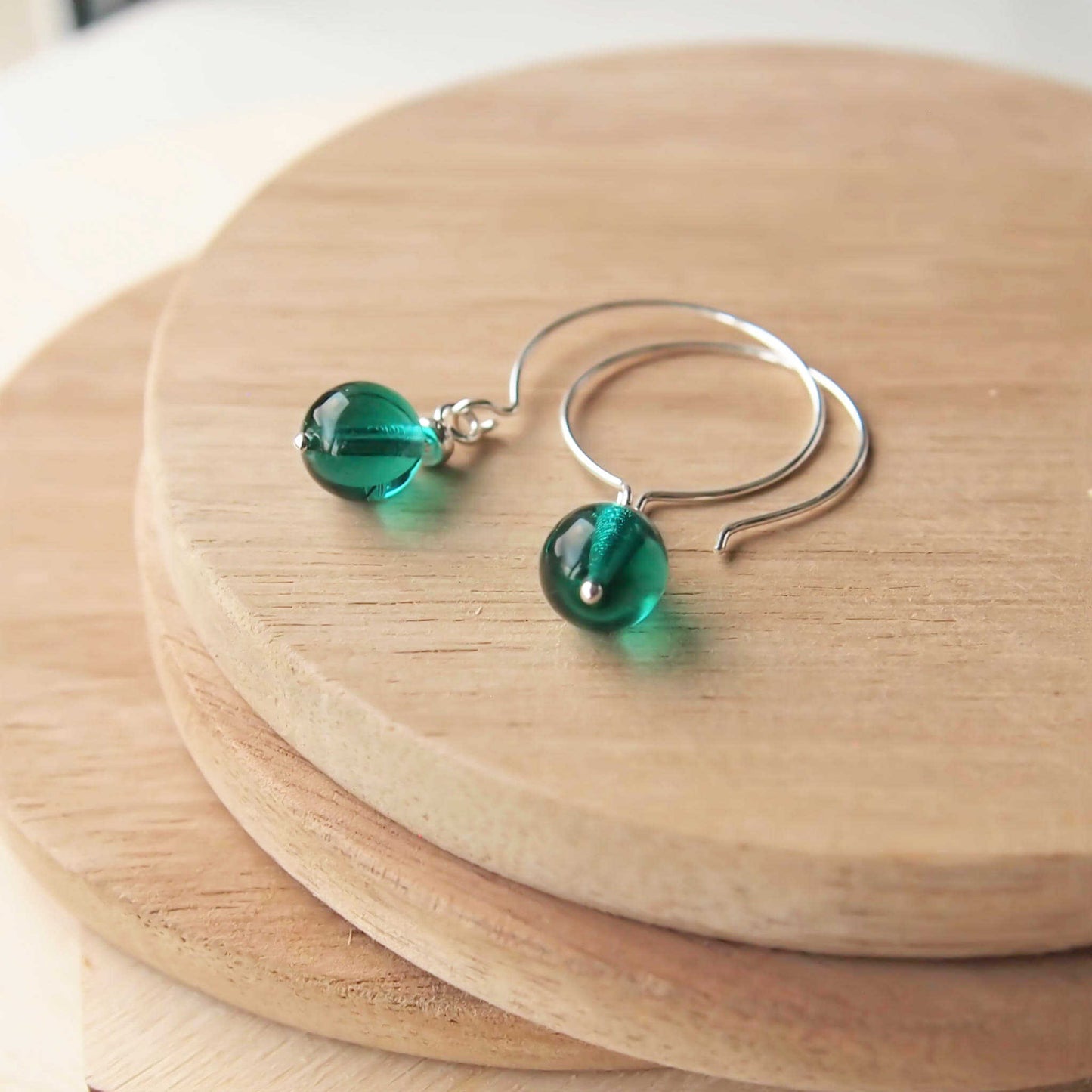 Green Silver minimalist handmade silver hoops. Handcrafted ear wires with a round glass bead dropper. Made in Scotland by maram jewellery