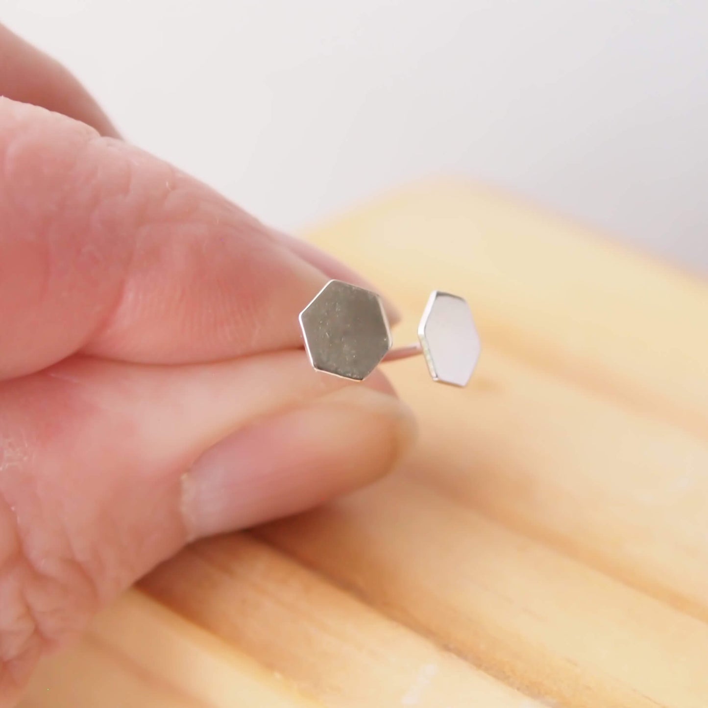 https://cdn.shopify.com/s/files/1/0067/8520/4309/files/hexagon_geometric_stud_earrings_web_2048.jpg?v=1665314943
