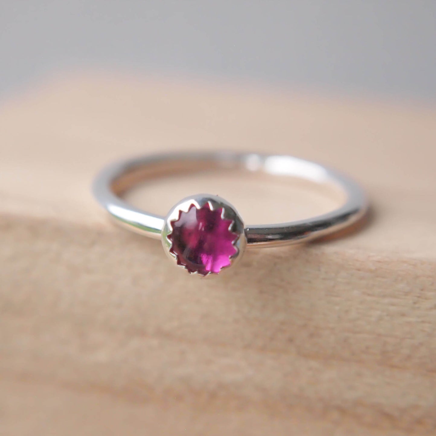 Single Solitaire simple style Sterling SIlver and A Lab Ruby pink Cabochon ring. The lab ruby gemstone is round and measure 5mm and it's set onto a band of fully round wire. It can be made to measure in any size. Handmade in Scotland by Maram Jewellery