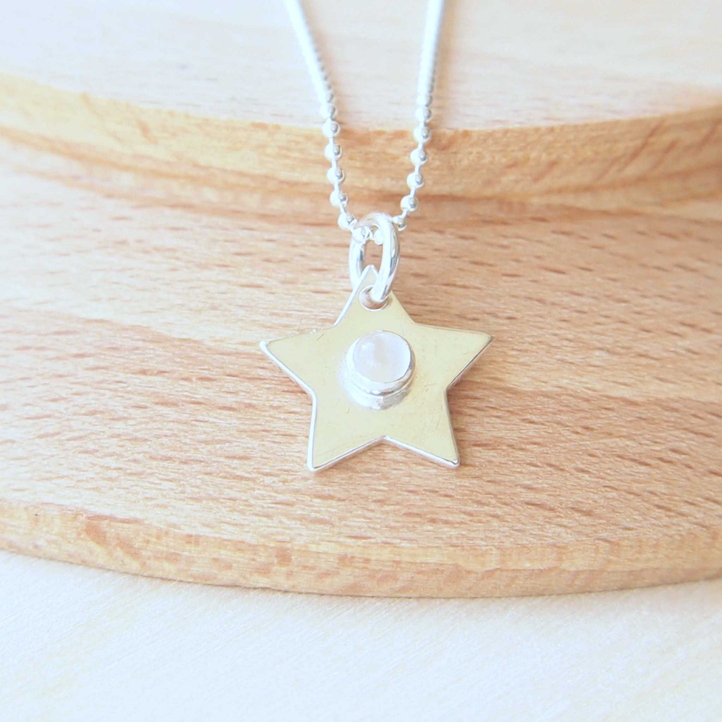 Silver Moonstone Star pendant on a chain with Junes Birthstone. Small Silver Star for all ages and simple in design. Handmde by a small jeweller in Edinburgh UK