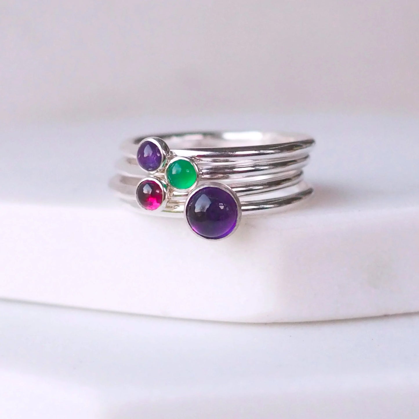 Amethyst, Garnet, Green Agate four ring set with two amethysts. Handmade in Scotland by maram jewellery. A four ring set with february, January and May Birthstones