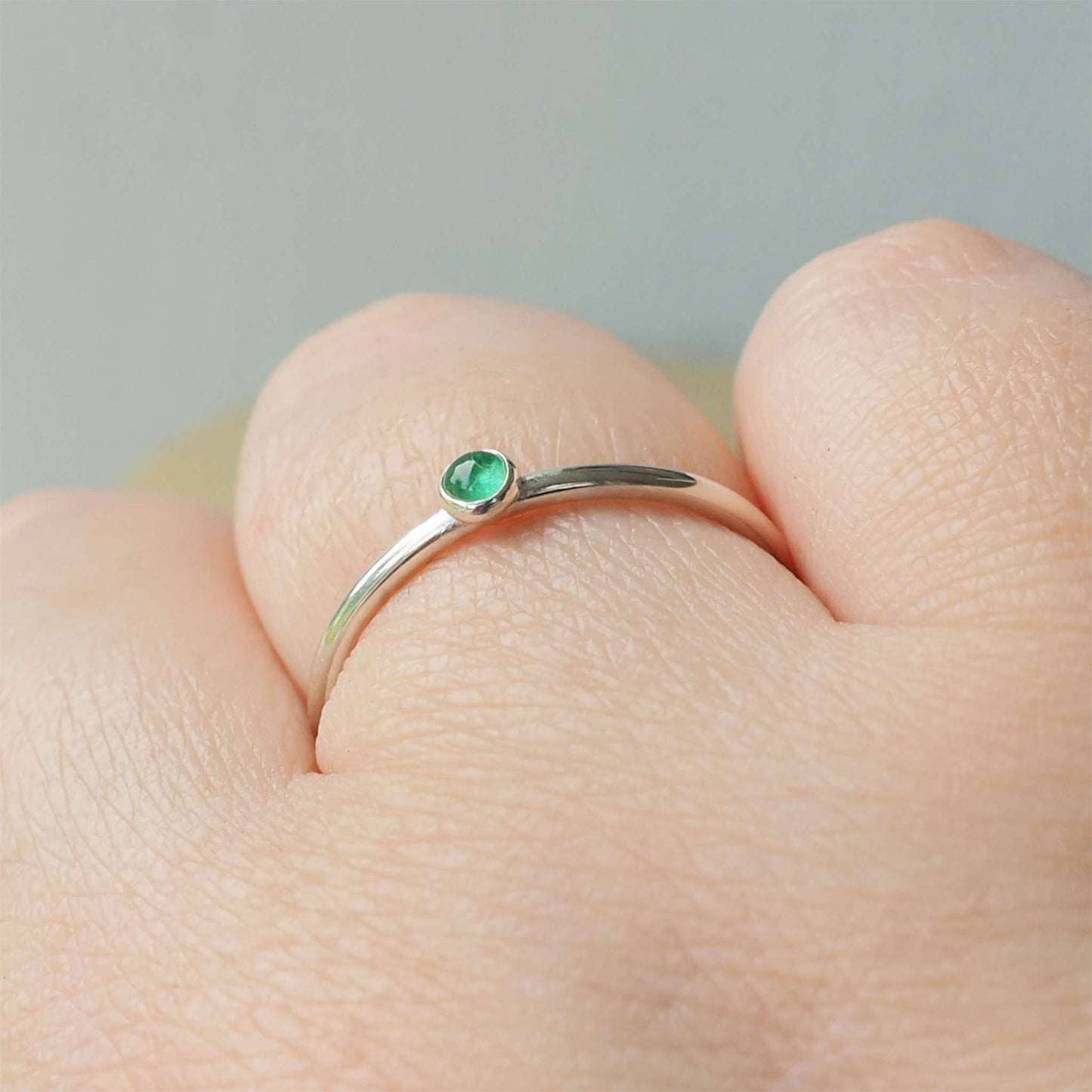 Simple Silver and Emerald ring with a round 3mm green emerald, May's Birthstone. Handmade by Maram Jewellery in Scotland