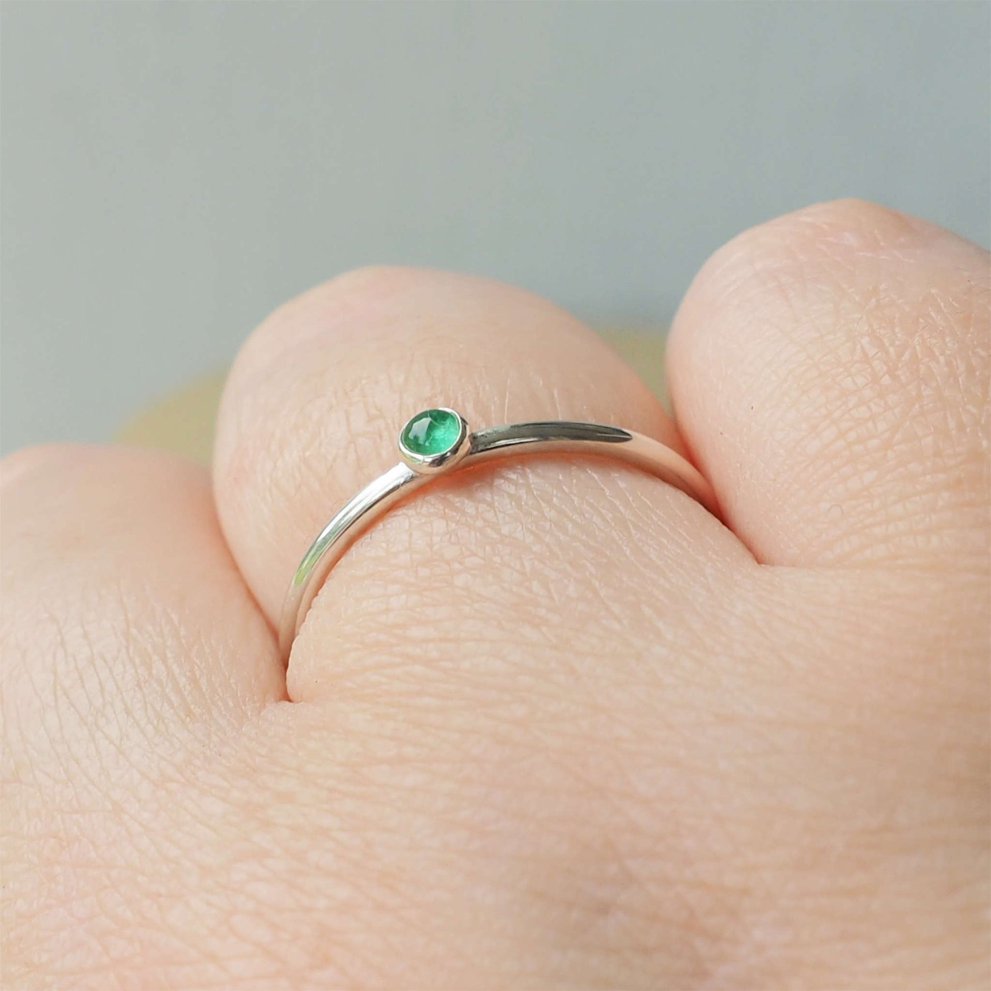 Simple Silver and Emerald ring with a round 3mm green emerald, May's Birthstone. Handmade by Maram Jewellery in Scotland