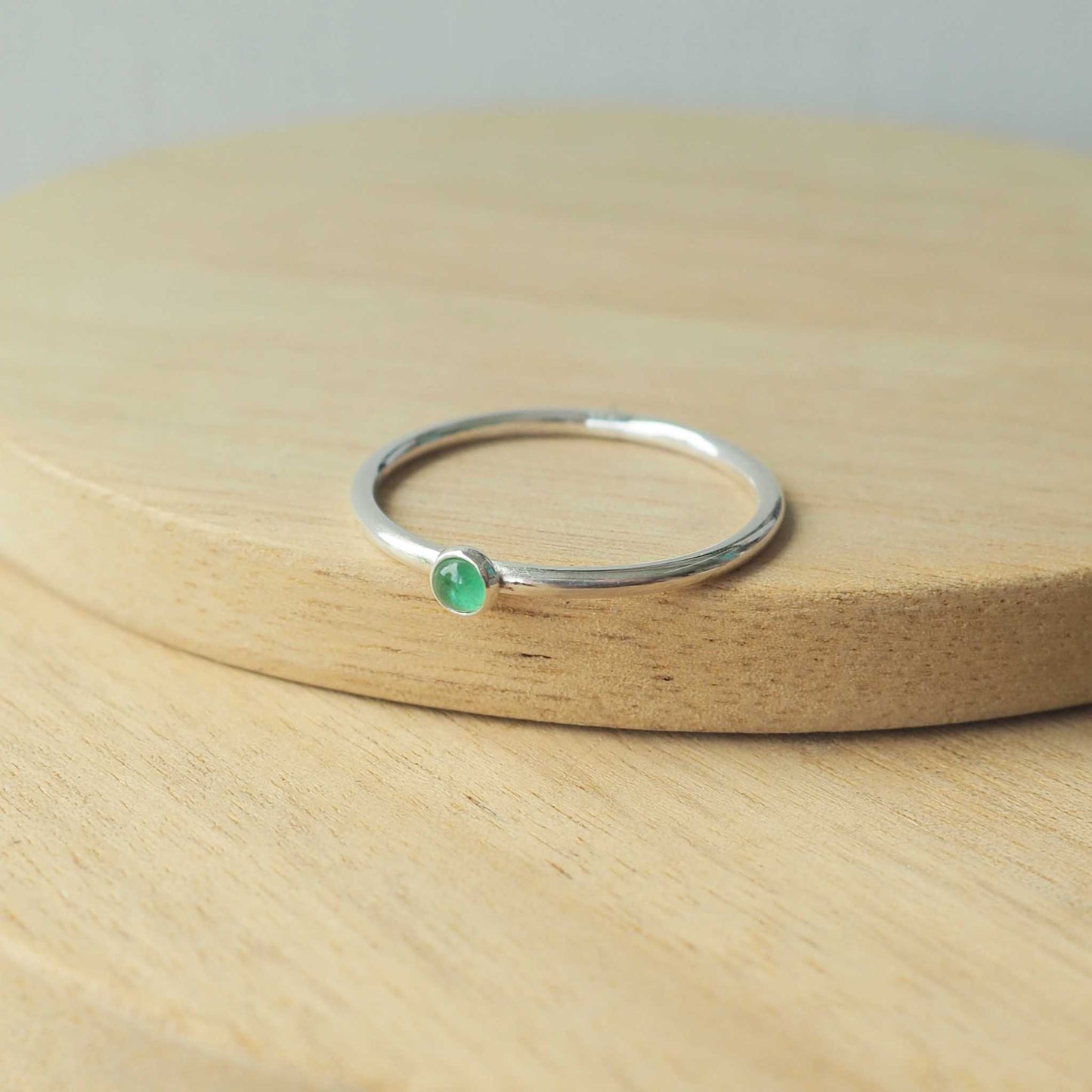 Simple Silver and Emerald ring with a round 3mm green emerald, May's Birthstone. Handmade by Maram Jewellery in Scotland