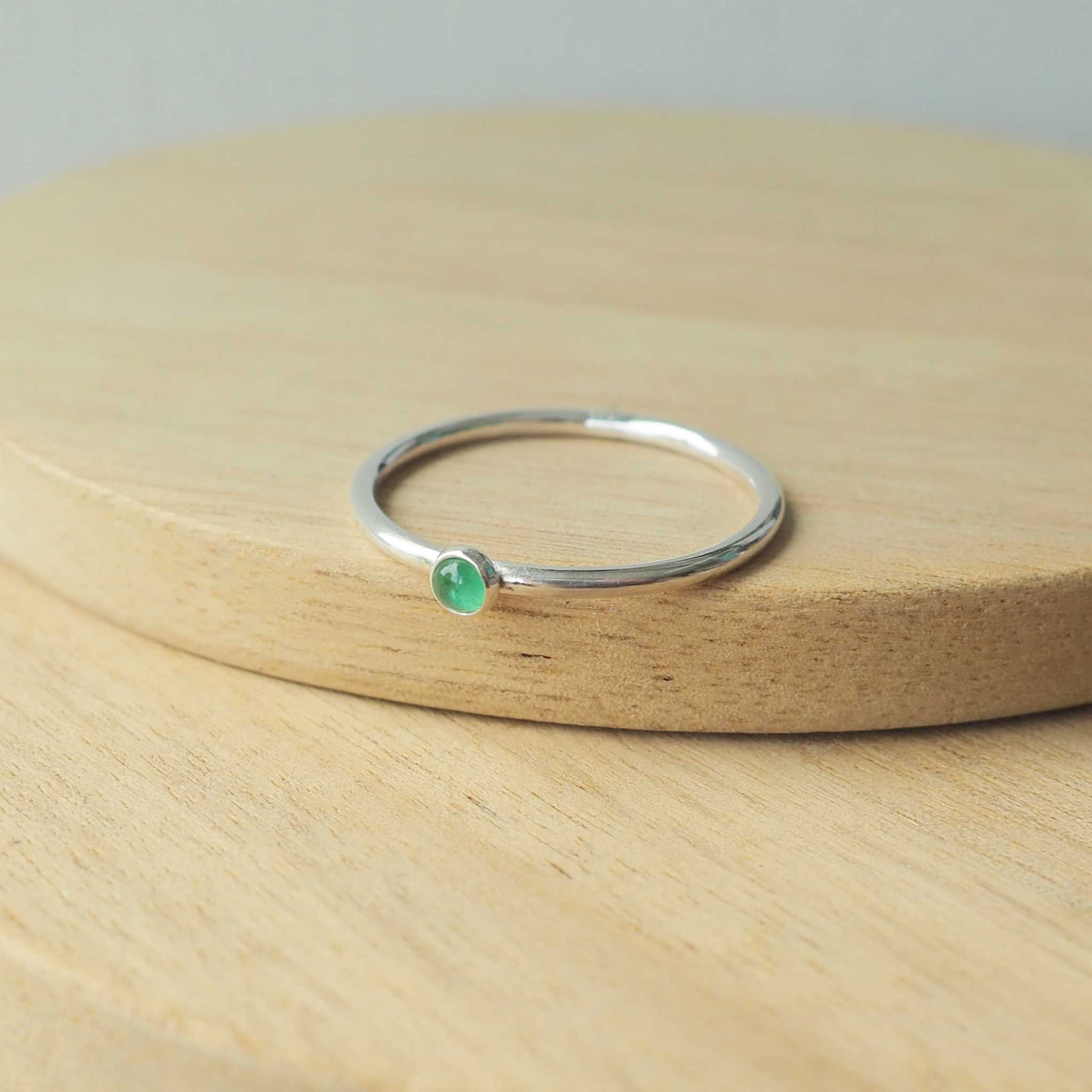 Simple Silver and Emerald ring with a round 3mm green emerald, May's Birthstone. Handmade by Maram Jewellery in Scotland