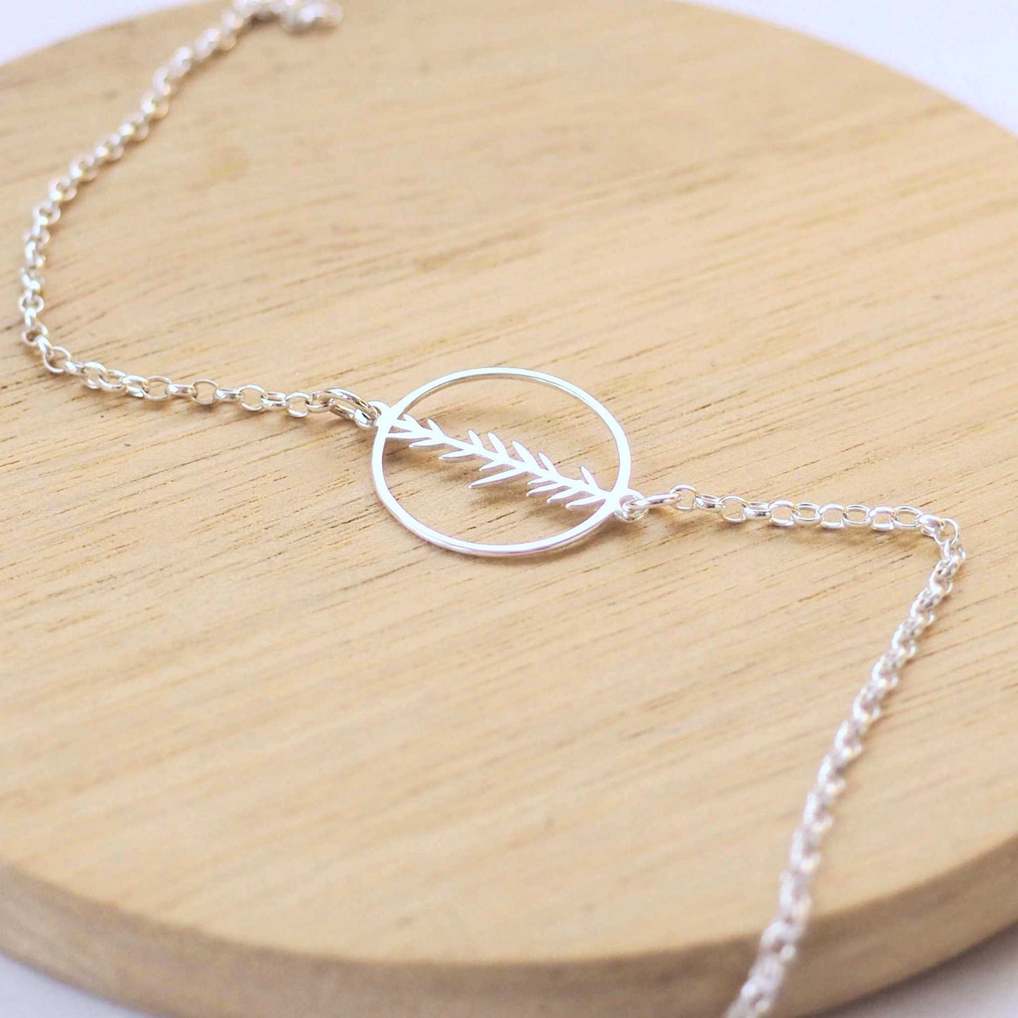 Fern Circle Silver bracelet with a circle with a cut out leaf pattern as a centre focal. Handmade by maram jewellery in Edinburgh UK