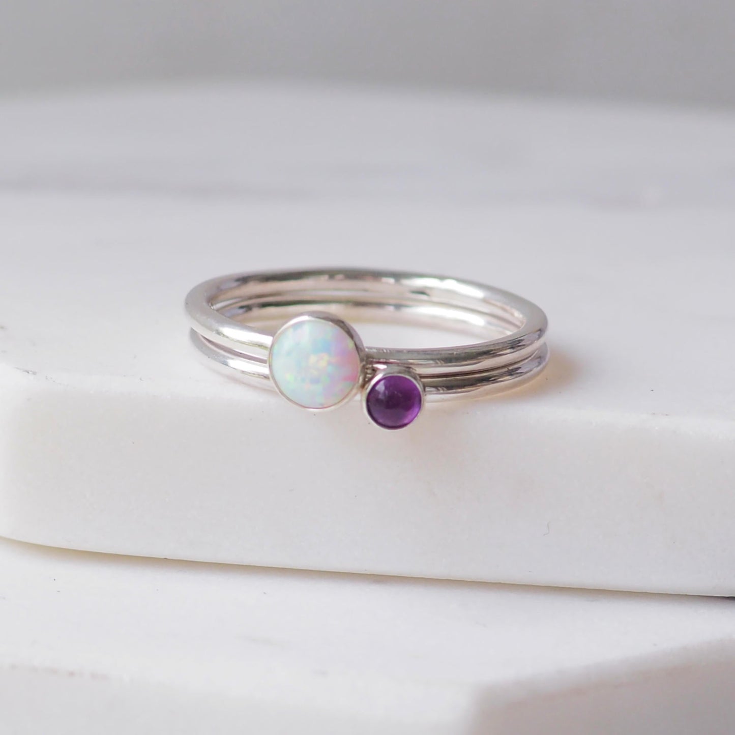 Two silver rings with lal Opal and Amethyst gemstones. Birthstones for February and October. Handmade to your ring size by maram jewellery in Scotland , UK