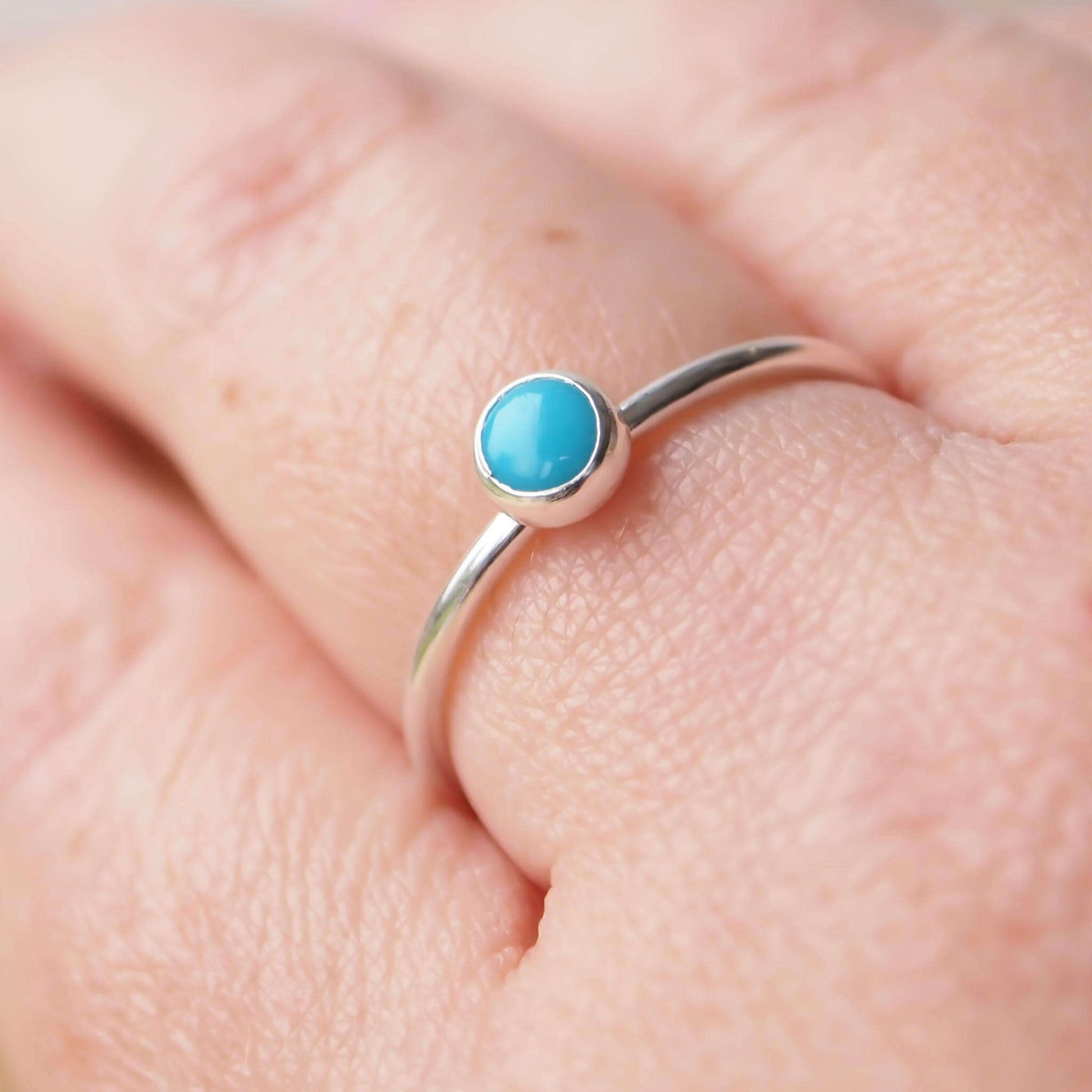 Turquoise and Sterling Silver Ring made from a small 5mm round turquoise gemstone set simply onto a modern band of round wire. Handmade to your ring size by maram jewellery in Scotland