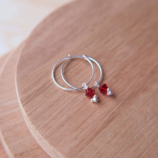 sterling silver hoops with birthstone crystals in ruby red