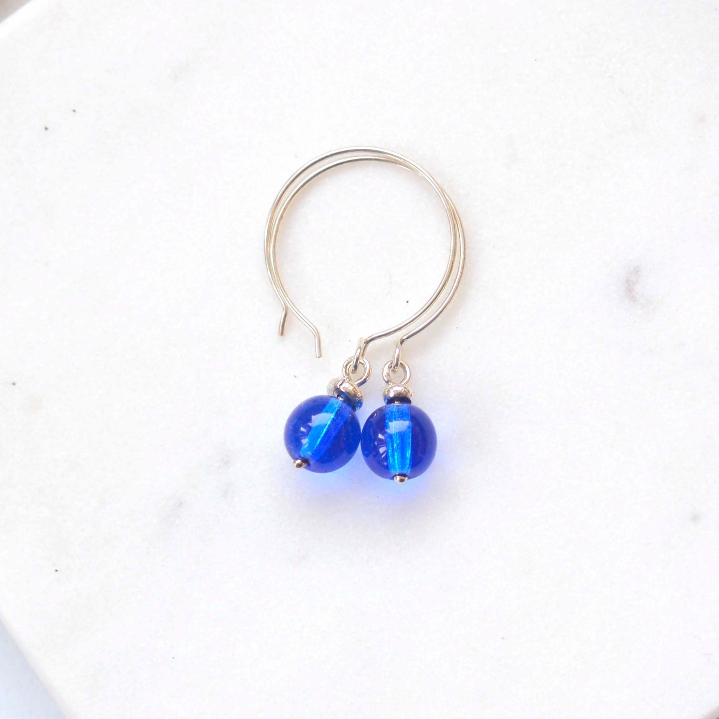 Cobalt blue Silver minimalist handmade silver hoops. Handcrafted ear wires with a round glass bead dropper. Made in Scotland by maram jewellery