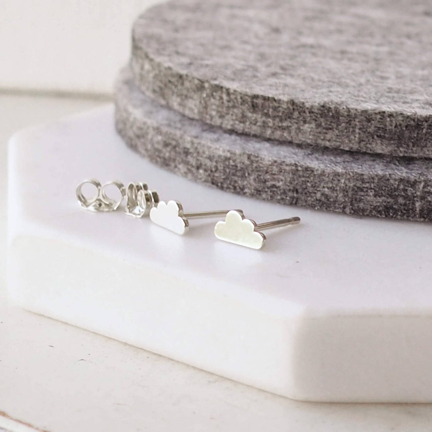 Little weather inspired cloud earrings in Sterling Silver pictured with butterfly back. available at maram jewellery, a small indie jeweller in Edinburgh UK