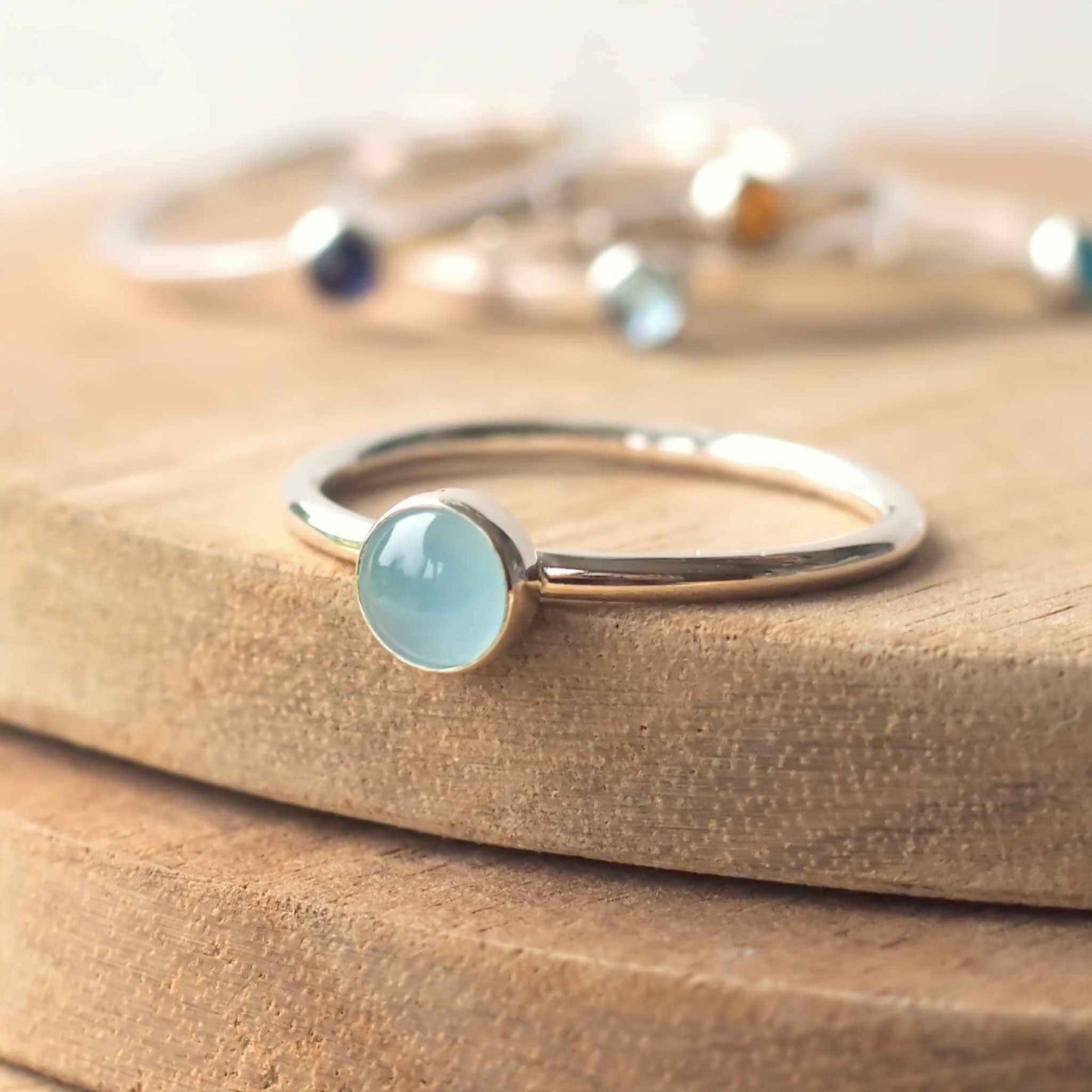 Cloudy Aquamarine birthstone ring for March. A 5mm round pale blue cabochon set simply onto a simple round band. The ring is made to measure to your size by maram jewellery in Scotland