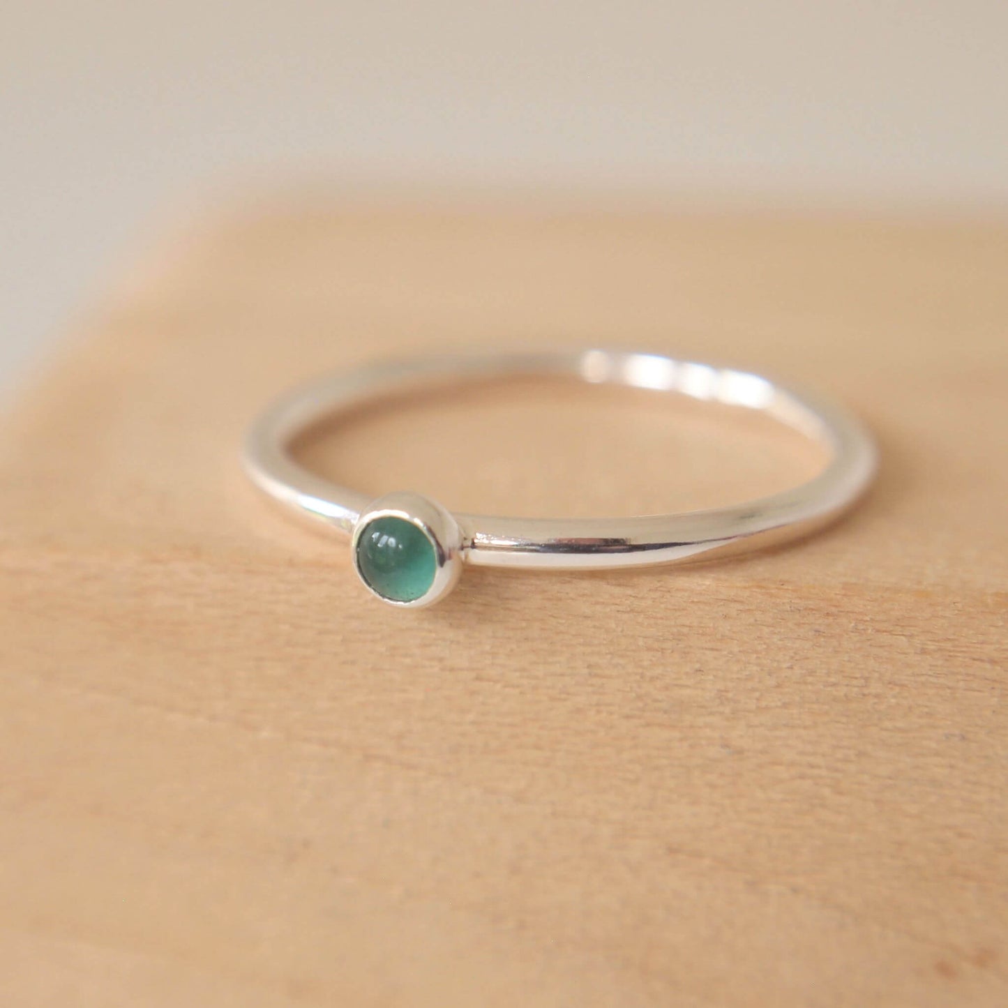 Green Agate and Sterling Silver Birthstone RIng for May. The ring is simple in style on a plain fully round band with a small round Green Agate in the centre. The ring is handmade to your size by maram jewellery in Scotland