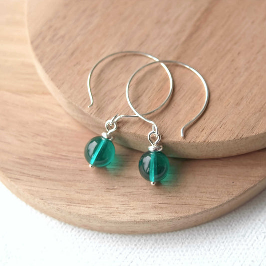 Green Silver minimalist handmade silver hoops. Handcrafted ear wires with a round glass bead dropper. Made in Scotland by maram jewellery