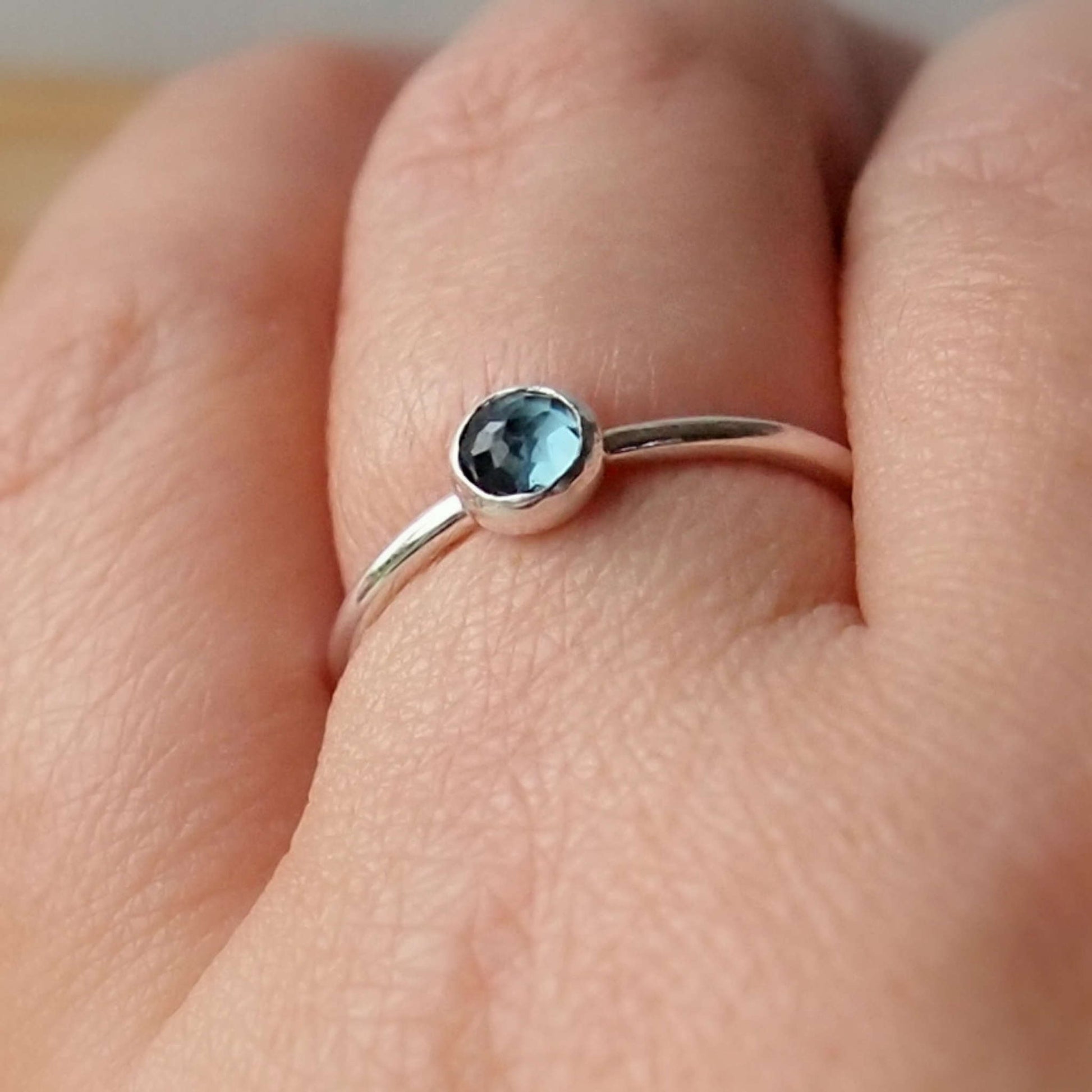 London Blue Topaz Sterling Silver Gemstone ring with a round 5mm facet cut teal Blue cabochon. Handmade in Scotland by maram jewellery