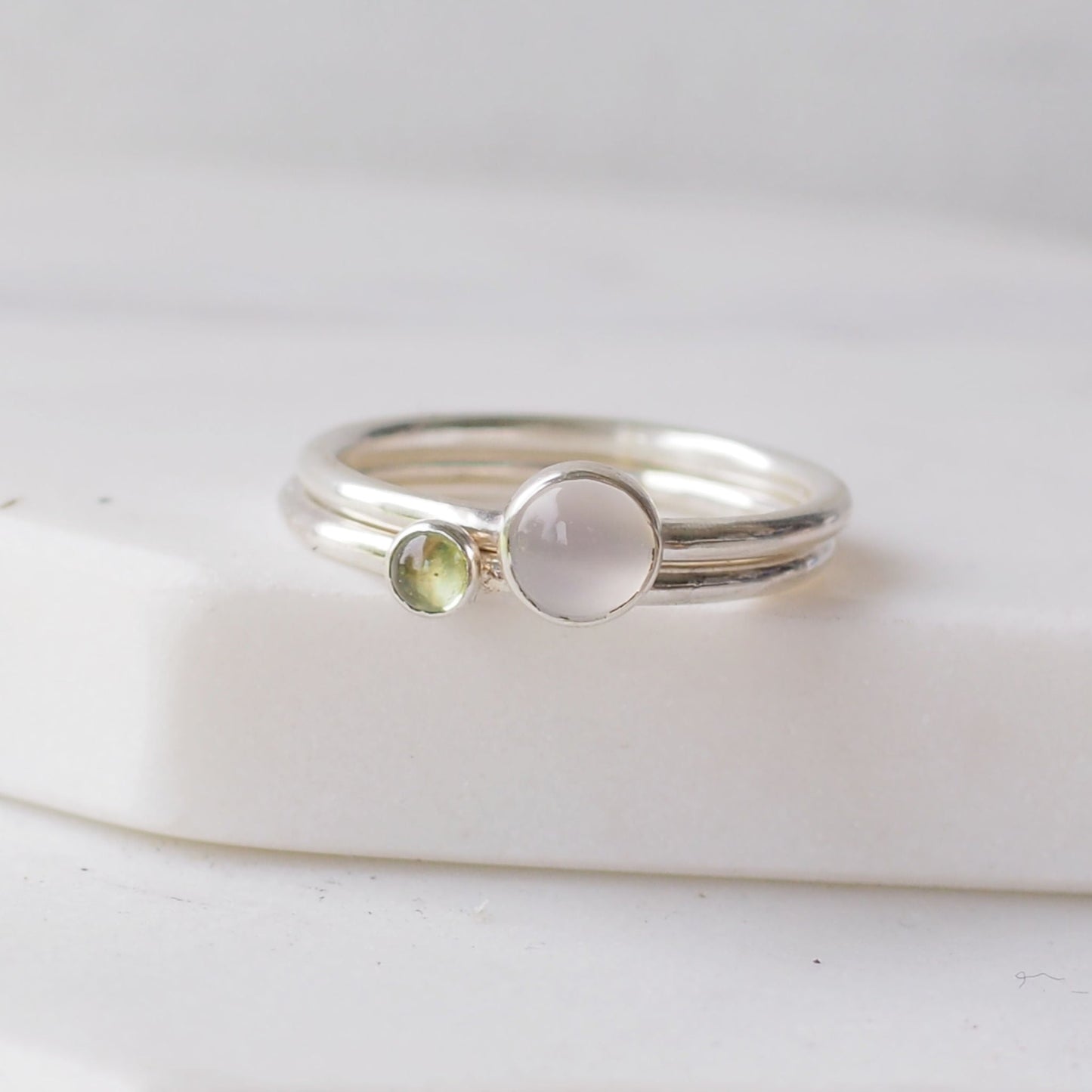Two silver rings with moonstone and peridot gemstones. Birthstones for June and August. Handmade to your ring size by maram jewellery in Scotland , UK
