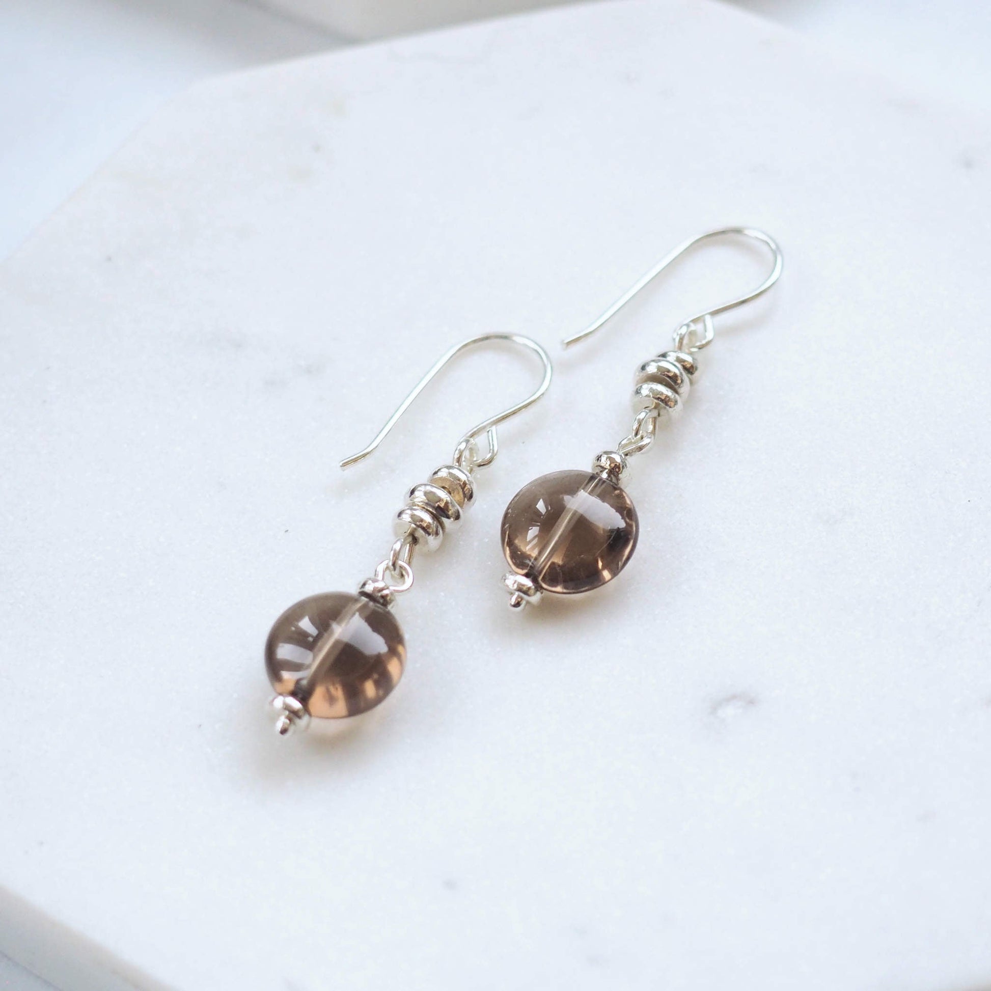Smoky Quartz and Sterling Silver dropper earrings. made from recycled silver beads and a 1cm round smoky quartz drop. Made in Scotland by maram jewellery