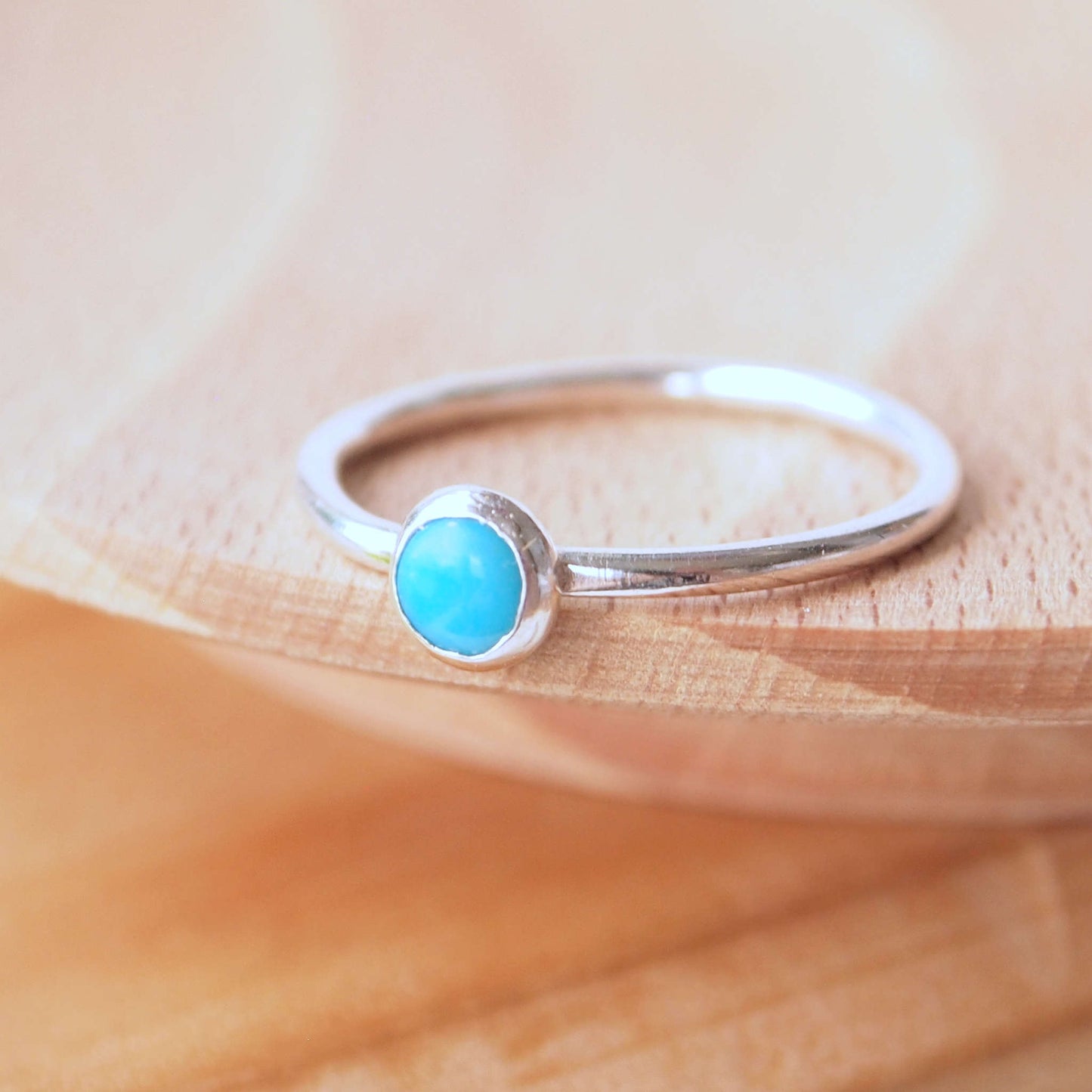 Turquoise and Sterling Silver Ring made from a small 5mm round turquoise gemstone set simply onto a modern band of round wire. Handmade to your ring size by maram jewellery in Scotland
