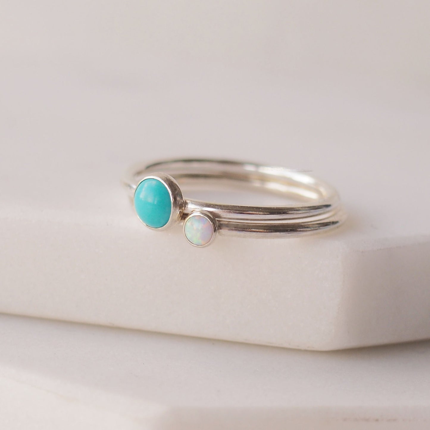 Two silver rings with Turquoise and Lab Opal gemstones. Birthstones for December and October. Handmade to your ring size by maram jewellery in Scotland , UK
