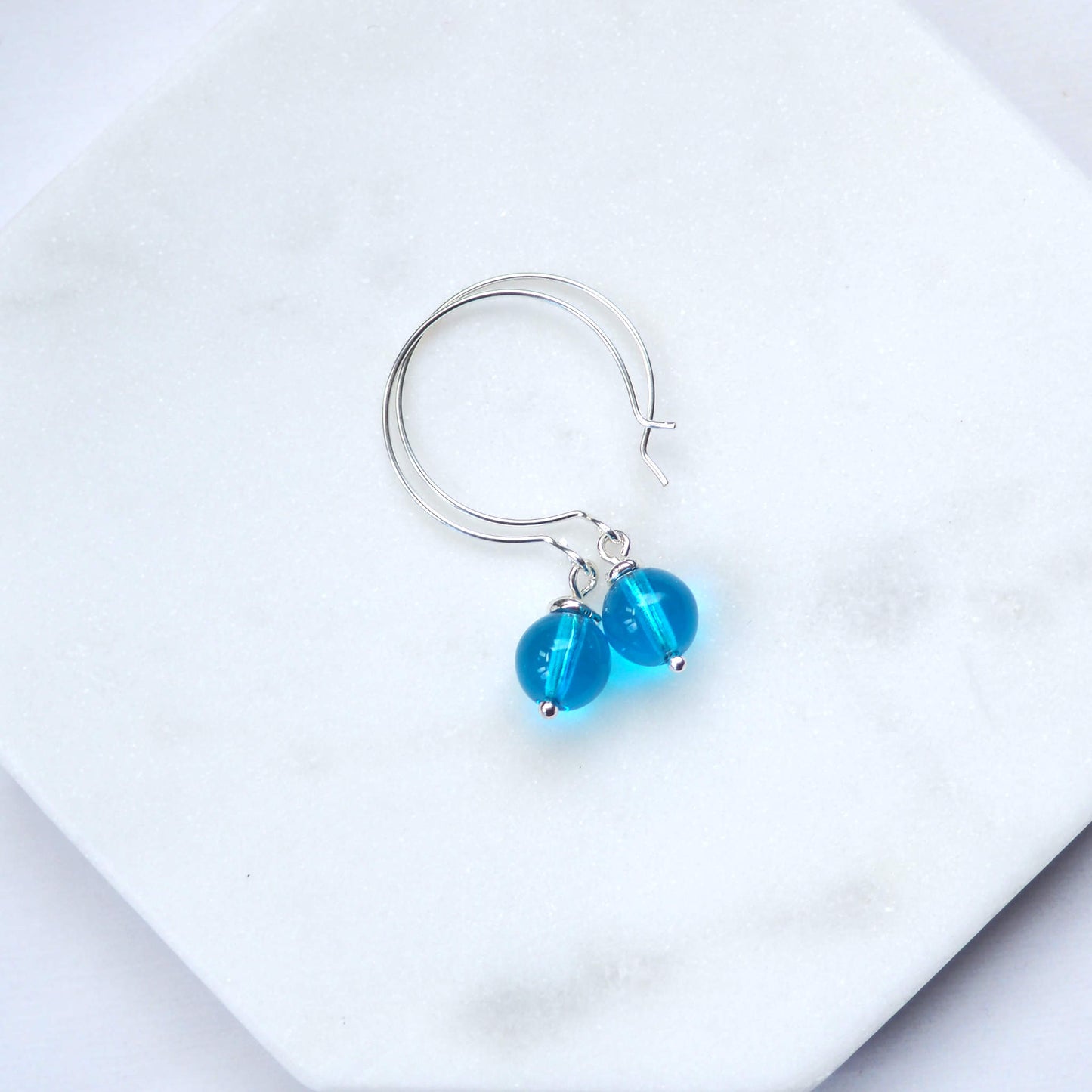 Turquoise Silver minimalist handmade silver hoops. Handcrafted ear wires with a round glass bead dropper. Made in Scotland by maram jewellery