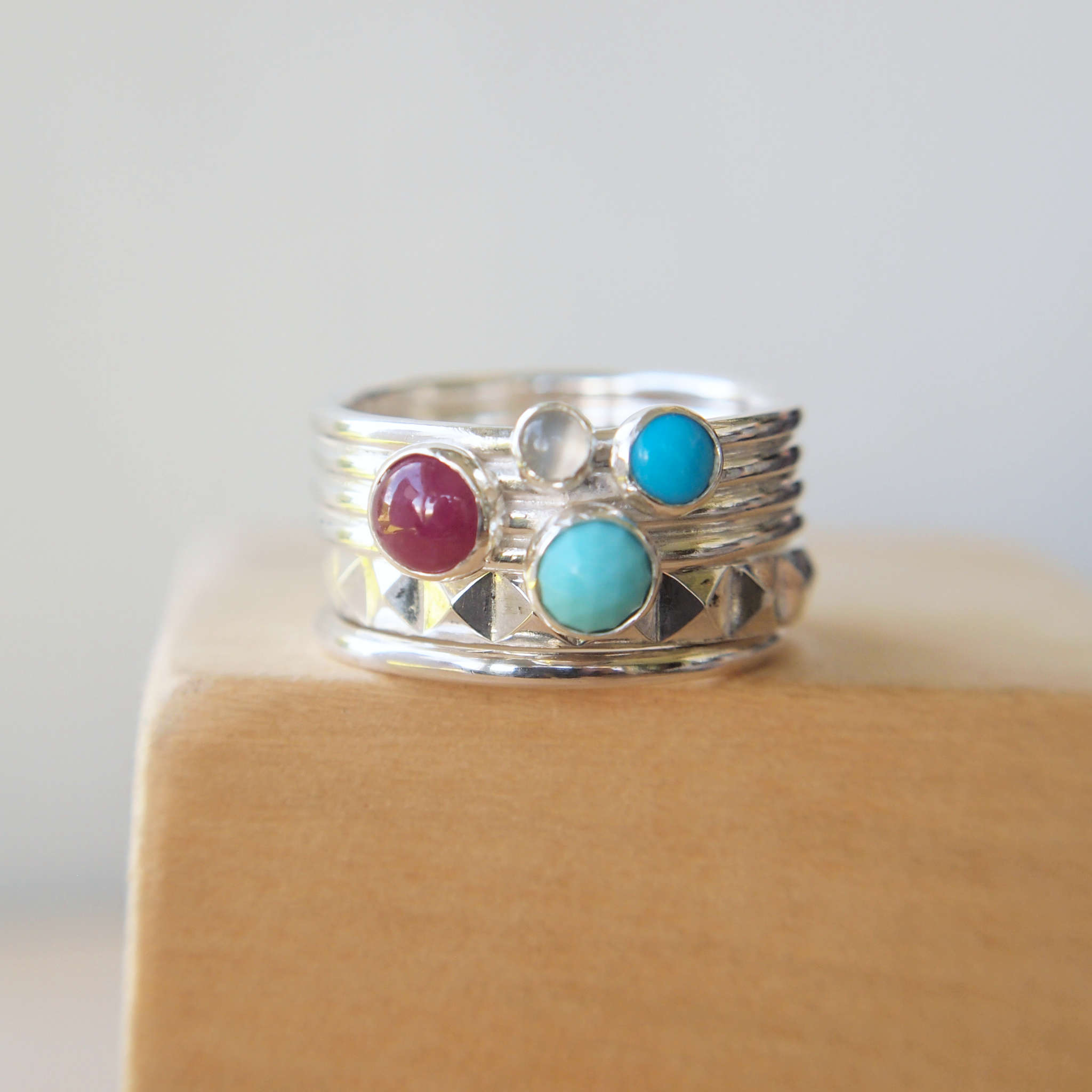 Custom made silver ring with turquoise and ruby in a stacking ring style. Handmade in Scotland by maram jewellery