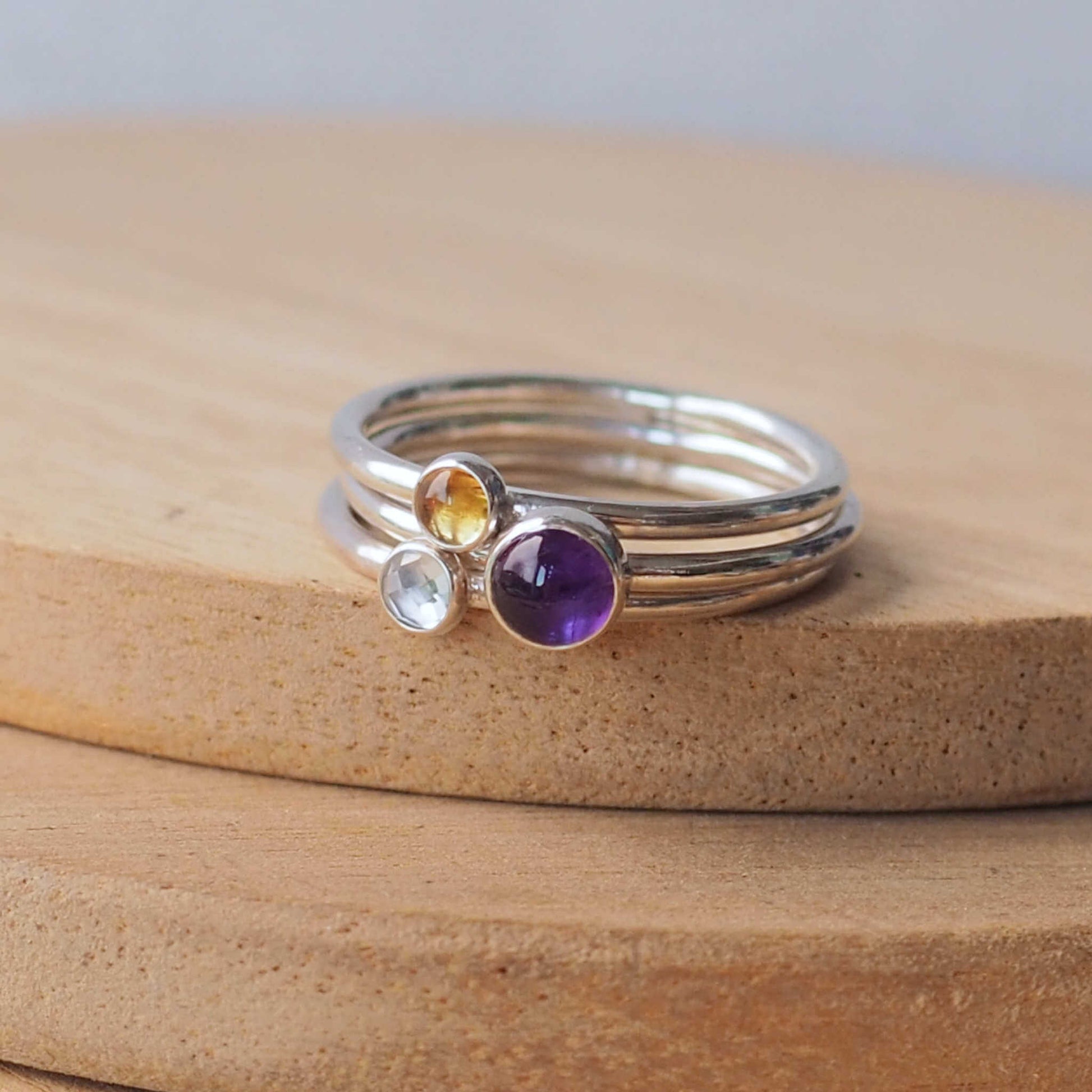 Three ring birthstone ring set made from sterling silver and three gemstones. This set has Amethyst, Blue Topaz and Citrine. Handmade in Scotland by Maram Jewellery