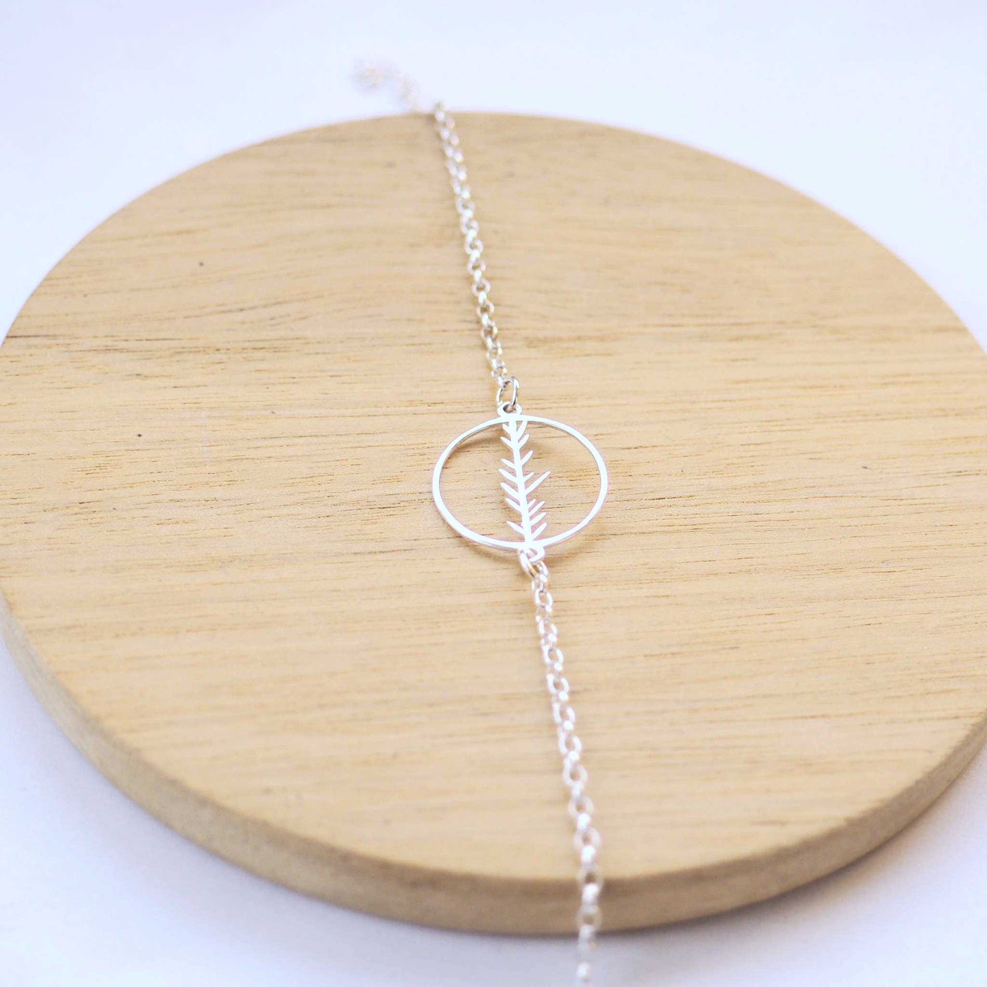 Fern Circle Silver bracelet with a circle with a cut out leaf pattern as a centre focal. Handmade by maram jewellery in Edinburgh UK