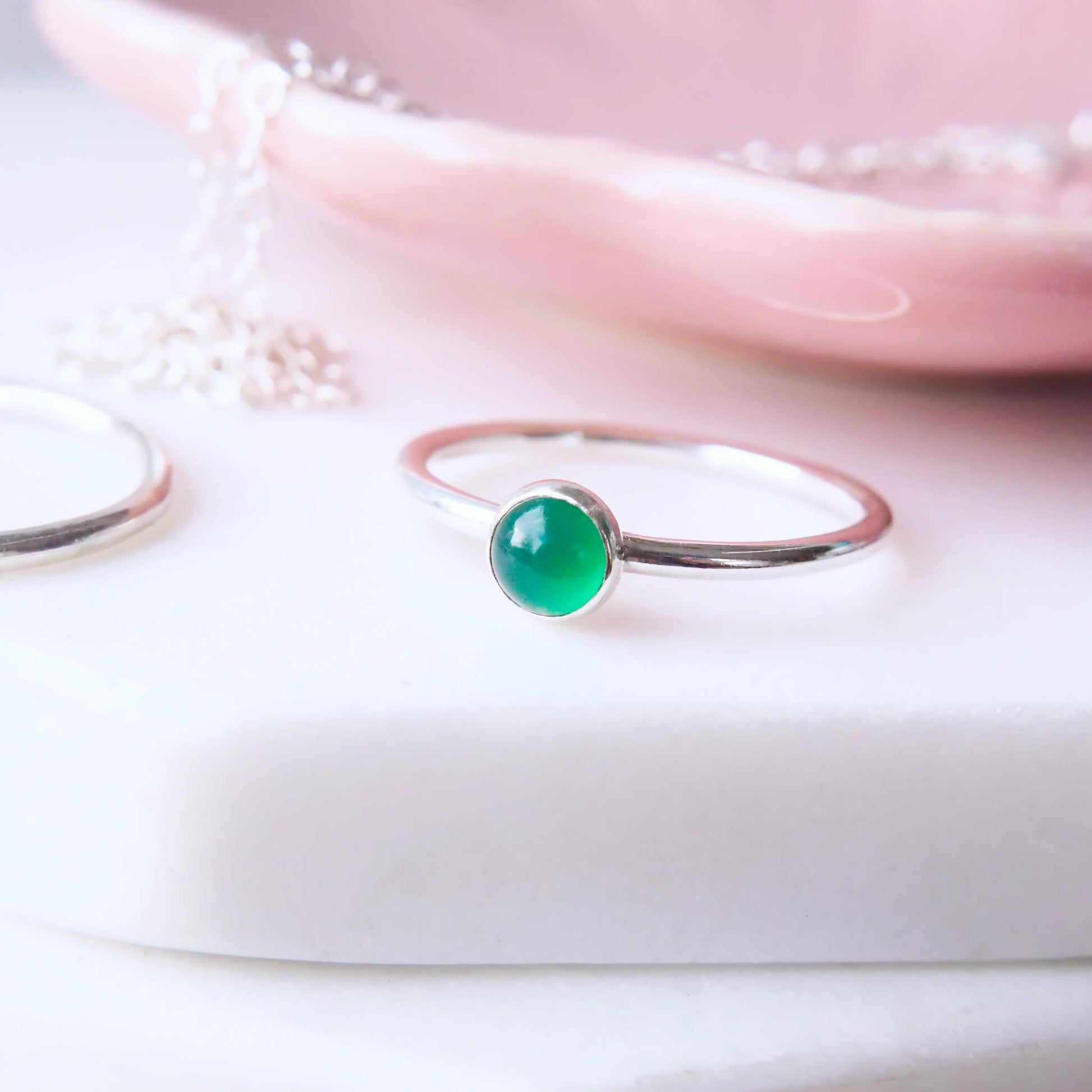 May Birthstone Cabochon Ring. Simple Style Green Agate Birthstone Ring for May. A round 5mm Emerald Green Agate Cabochon set onto a halo band of Sterling Silver. Handmade to your ring size by maram jewellery in UK