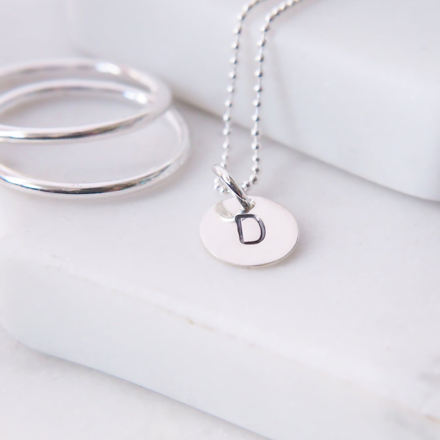 Letter pendant with D letter.Simple SIlver disc pendant with an initial, 8mm in size handmade by maram jewellery