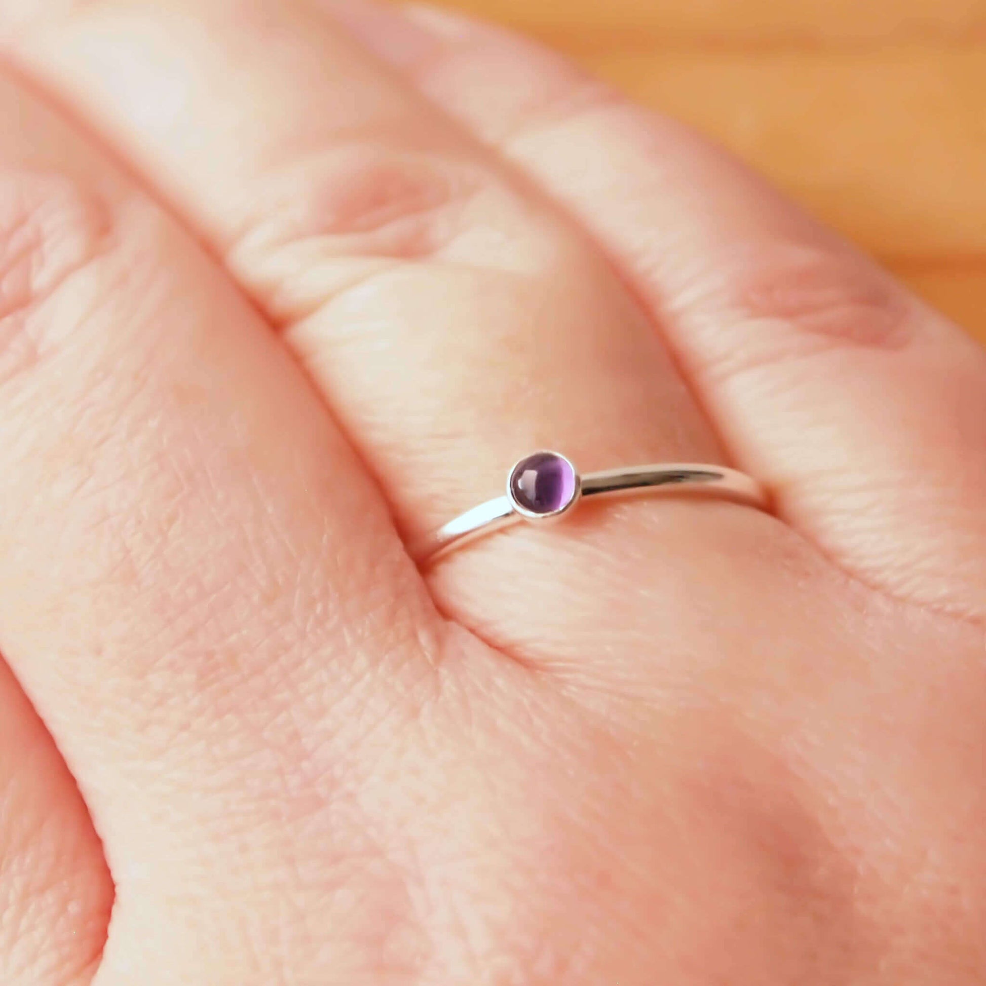 Amethyst and Sterling Silver Ring made from a small 3mm round deep purple Amethyst gemstone set simply onto a modern band of fully round wire. Handmade to your ring size by maram jewellery in Scotland