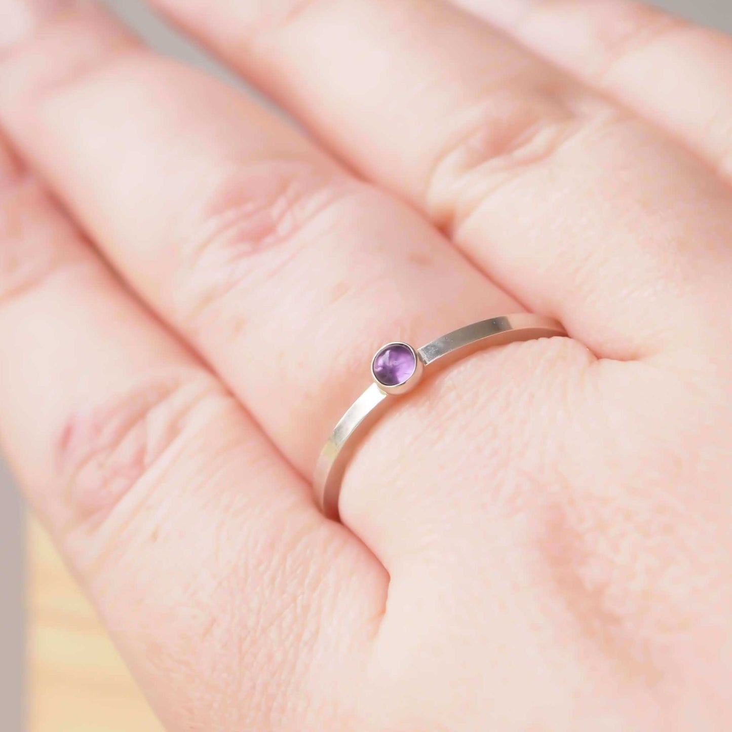 Amethyst and Sterling Silver Ring made from a small 3mm round deep purple Amethyst gemstone set simply onto a modern band of square wire. Handmade to your ring size by maram jewellery in Scotland