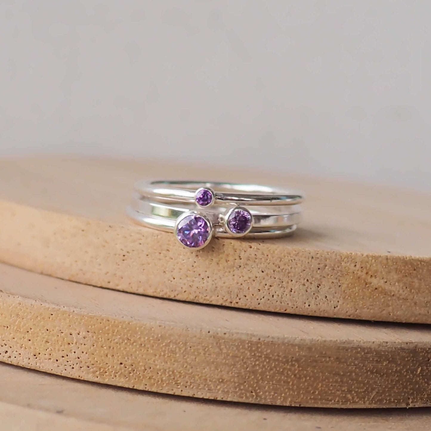 Set of three Purple amethyst silver rings with round gemstones in different sizes. Made from Cubic Zirconia and Sterling Silver.  Handmade in Scotland UK by maram jewellery