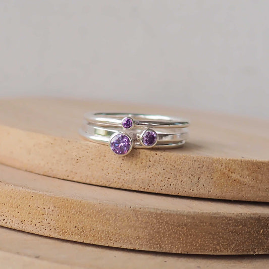 Set of three Purple amethyst silver rings with round gemstones in different sizes. Made from Cubic Zirconia and Sterling Silver.  Handmade in Scotland UK by maram jewellery