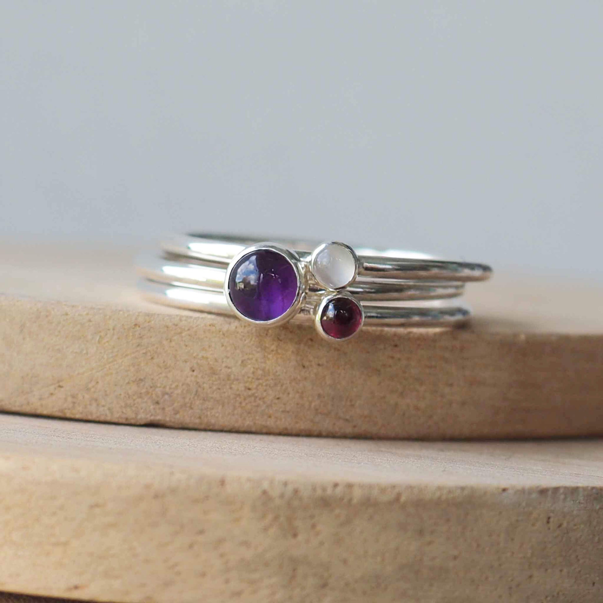 Three ring birthstone ring set made from sterling silver and three gemstones. This set has Amethyst, Garnet and Moonstone. Handmade in Scotland by Maram Jewellery