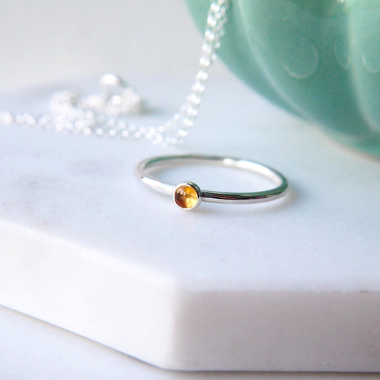 Citrine and Sterling Silver Ring made from a small 3mm round warm yellow citrine gemstone set simply onto a modern band of fully round wire. Handmade to your ring size by maram jewellery in Scotland