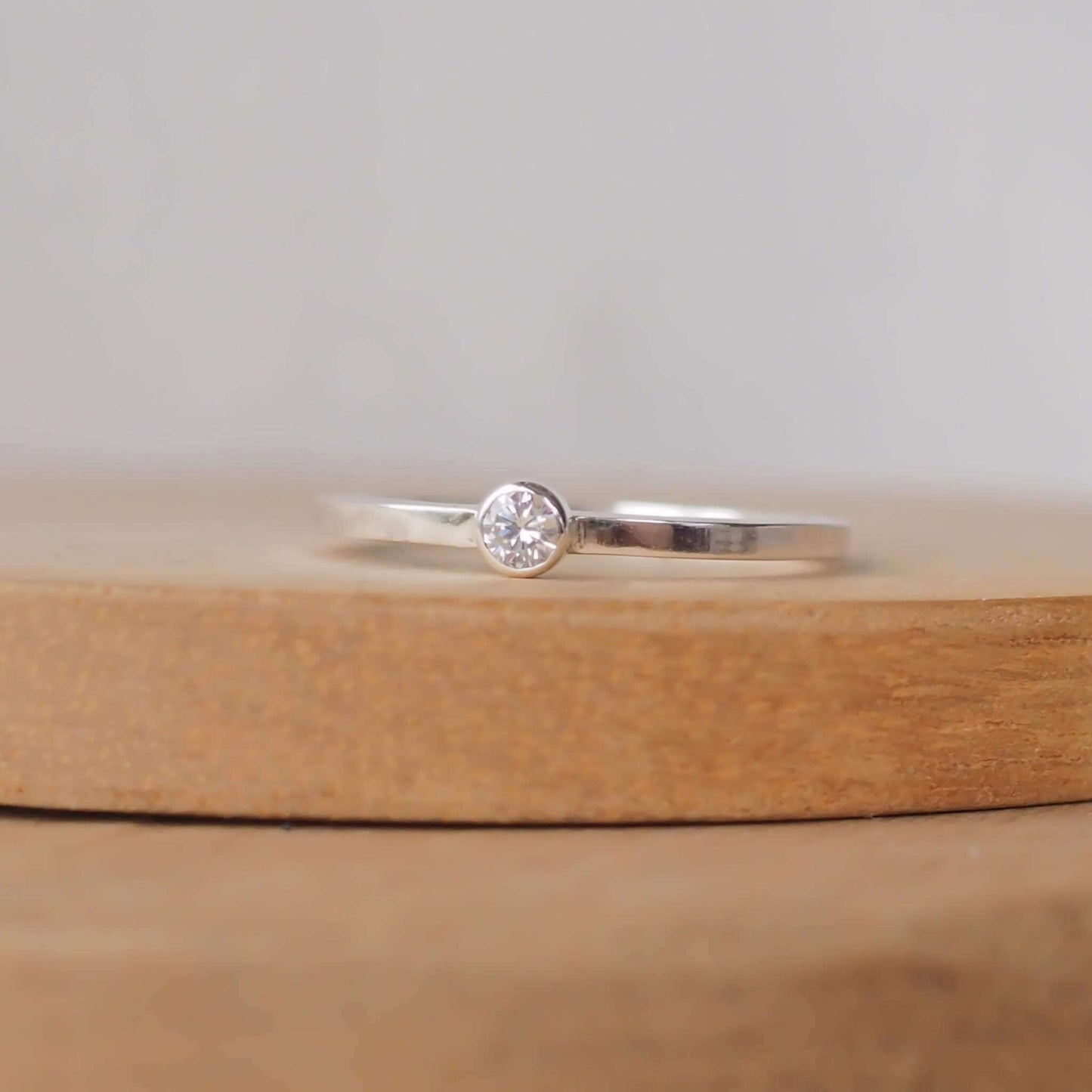 Minimalist style small gemstone Solitaire ring in sterling silver with a square wire band and a 3mm round cubic zirconia. Handmade in Scotland UK by maram jewellery