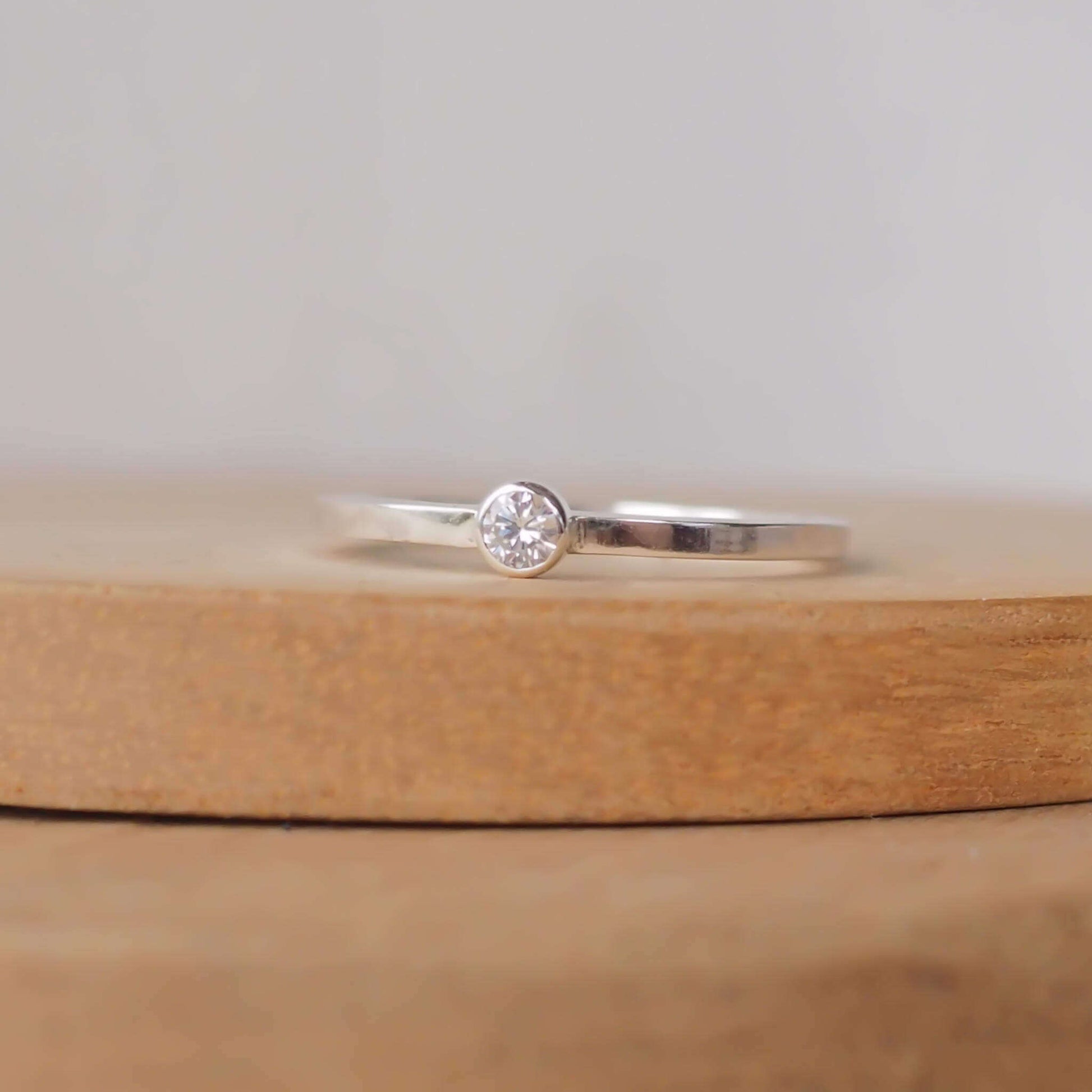 Minimalist style small gemstone Solitaire ring in sterling silver with a square wire band and a 3mm round cubic zirconia. Handmade in Scotland UK by maram jewellery