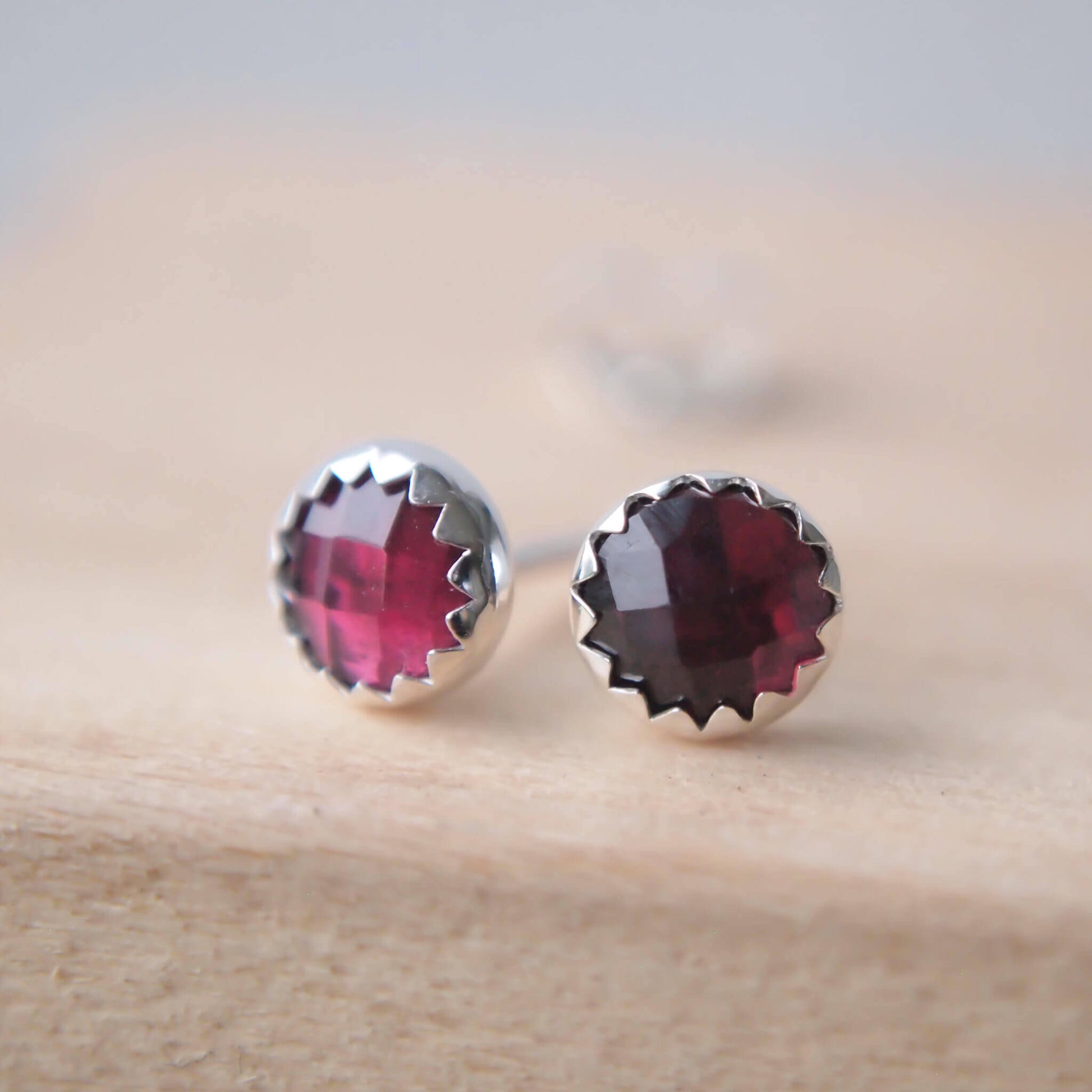 Simple minimalist sterling silver gemstone earrings with a round sparkly garnet gemstone, birthstone for January. Thea earrings are round, measuring 5mm with the gemstone being the main feature. Handmade in Scotland by Maram Jewellery