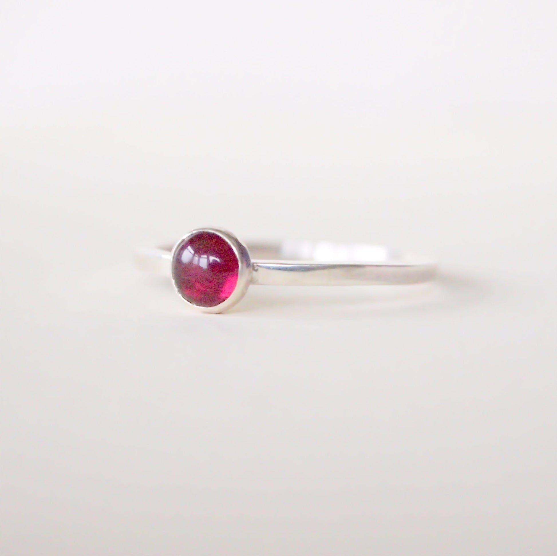 Sterling Silver and Garnet birthstone ring with a rich red 5mm round garnet. Handcrafted in Scotland by Maram Jewellery