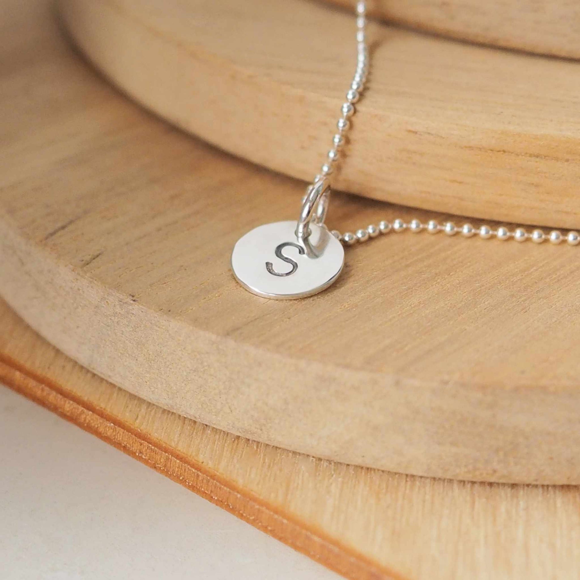 Letter pendant with S letter.Simple SIlver disc pendant with an initial, 8mm in size handmade by maram jewellery