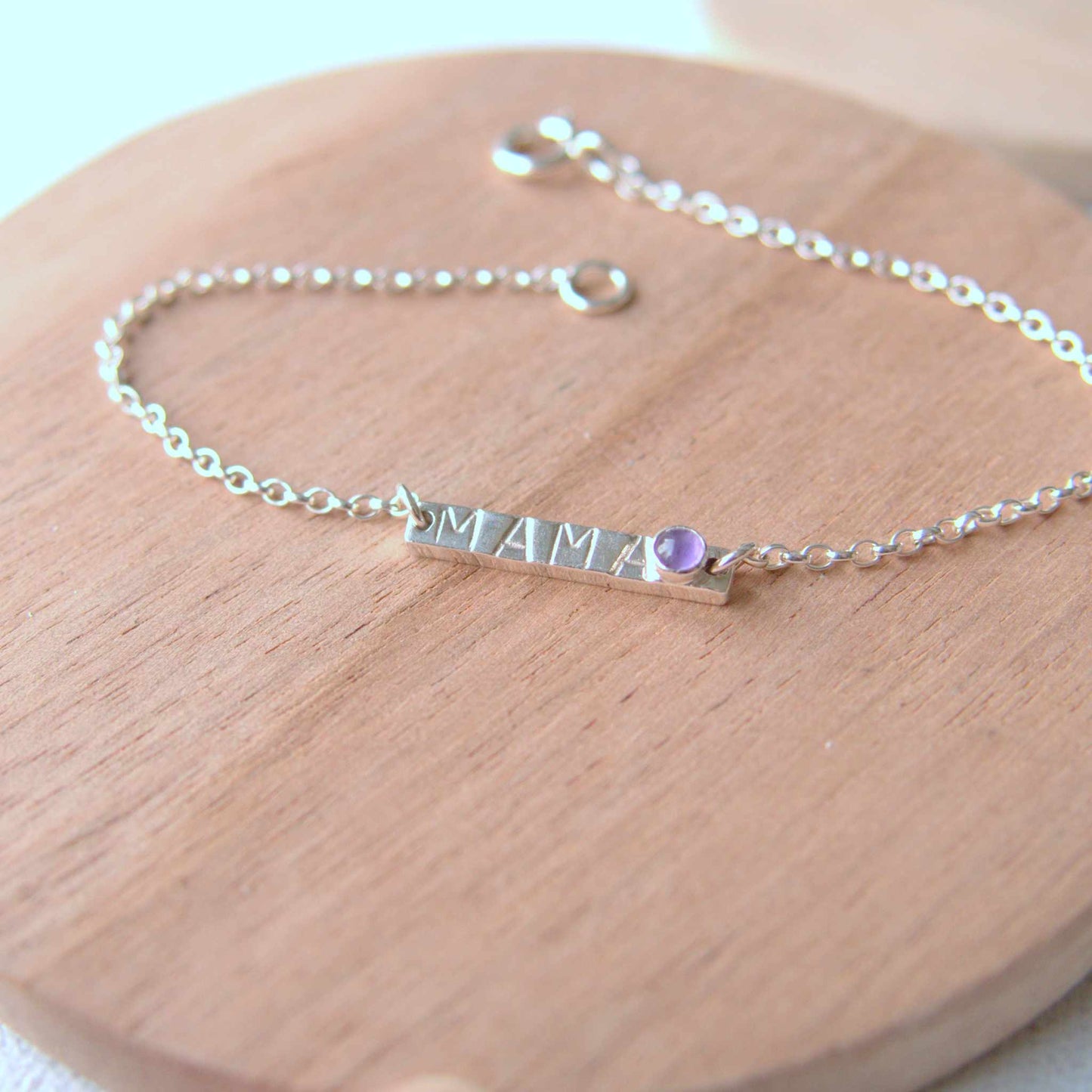 Silver Bar bracelet with handstamped MAMA with a baby birthstone in February Amethyst. Handmade by maram jewellery in Scotland UK