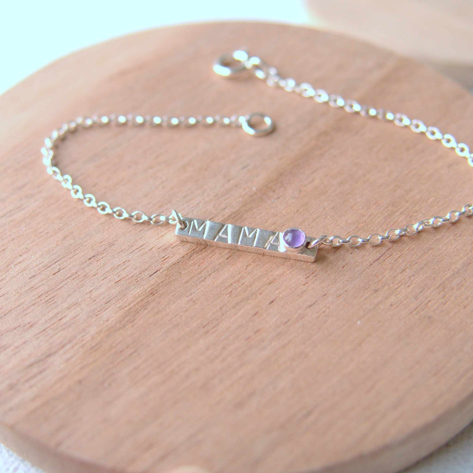Silver Bar bracelet with handstamped MAMA with a baby birthstone in February Amethyst. Handmade by maram jewellery in Scotland UK